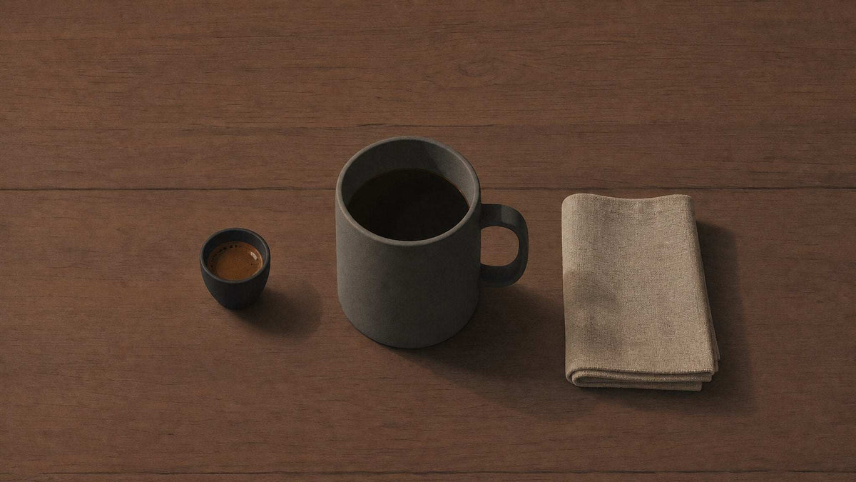 Coffee mug gift set with a charcoal gray ceramic mug, small espresso cup, and folded beige napkin; Coffee Mug Gift Ideas