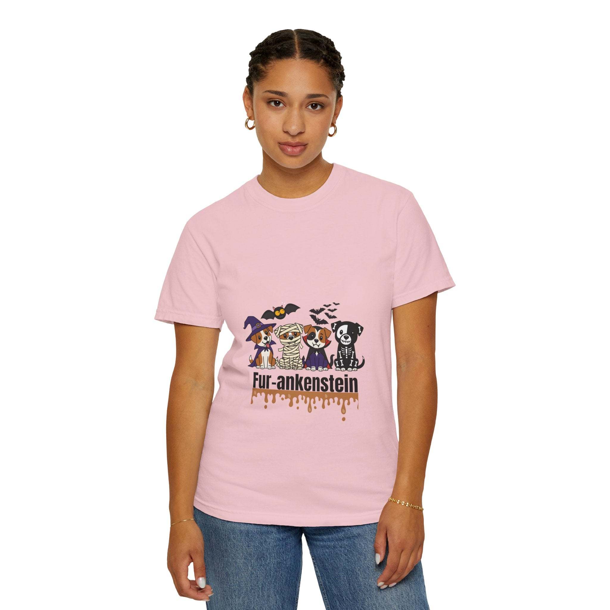 Woman wearing a pink Puppies Halloween T-shirt with puppies in costumes and "Fur-ankenstein" text