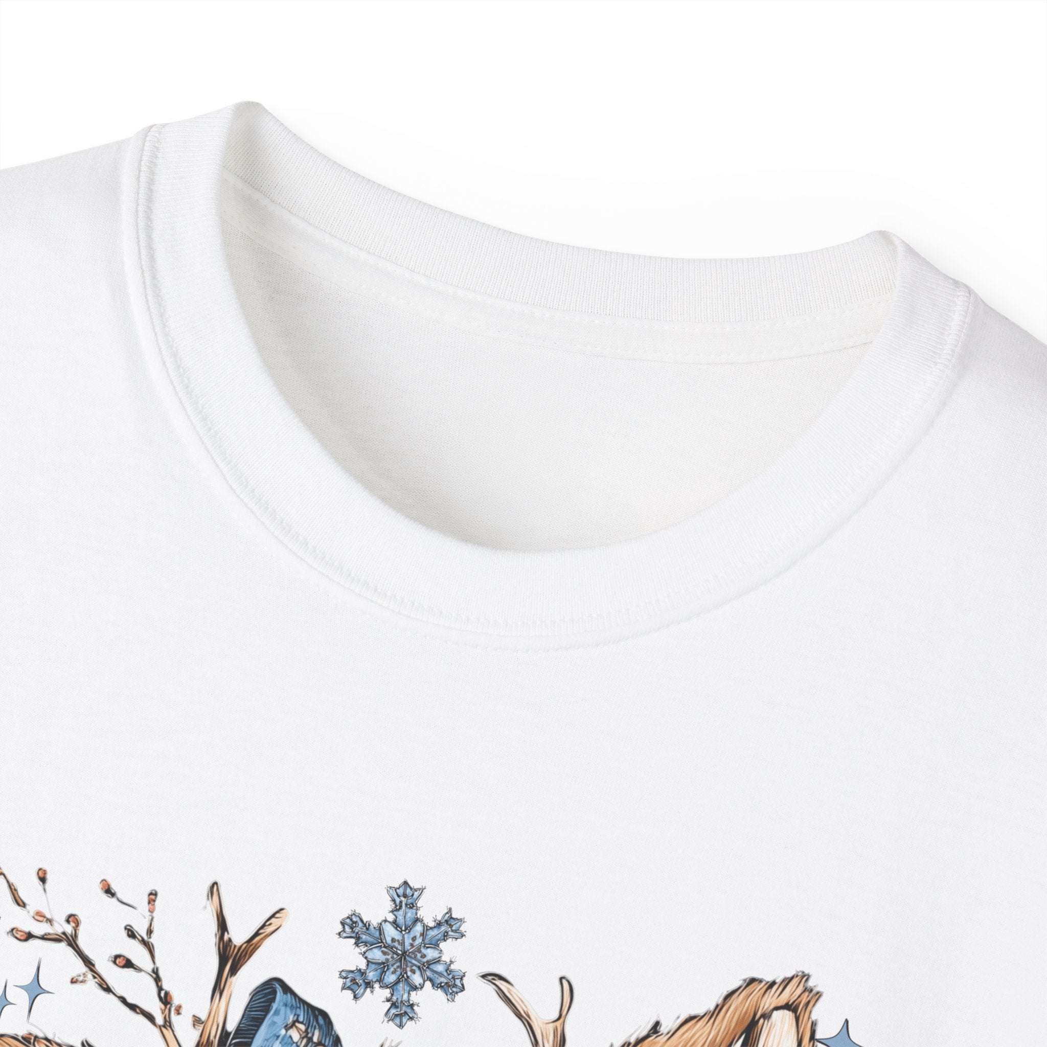 White t-shirt with retro patchwork reindeer design wearing blue scarf and surrounded by snowflakes