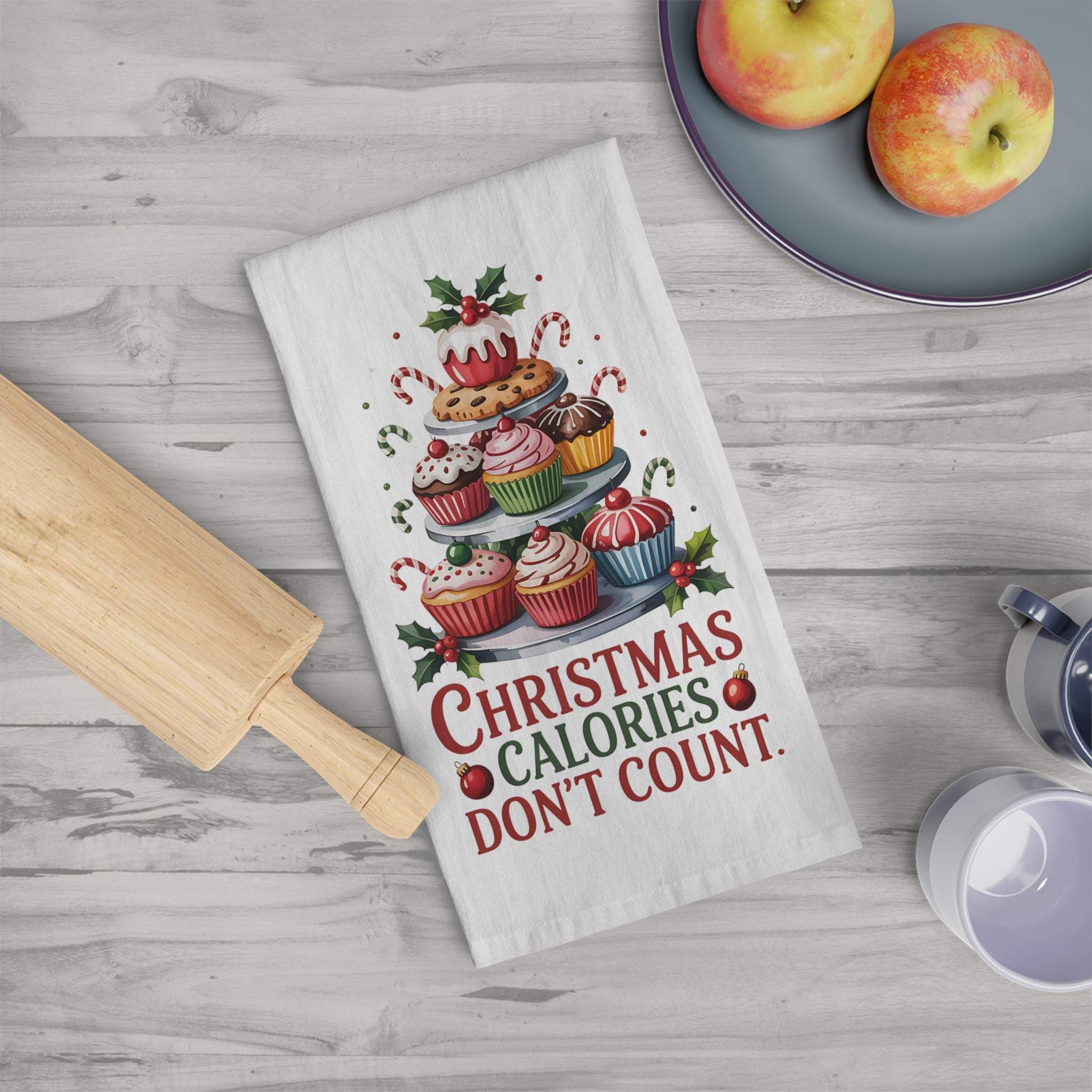Christmas kitchen towel with "Christmas calories don't count" text and festive dessert design