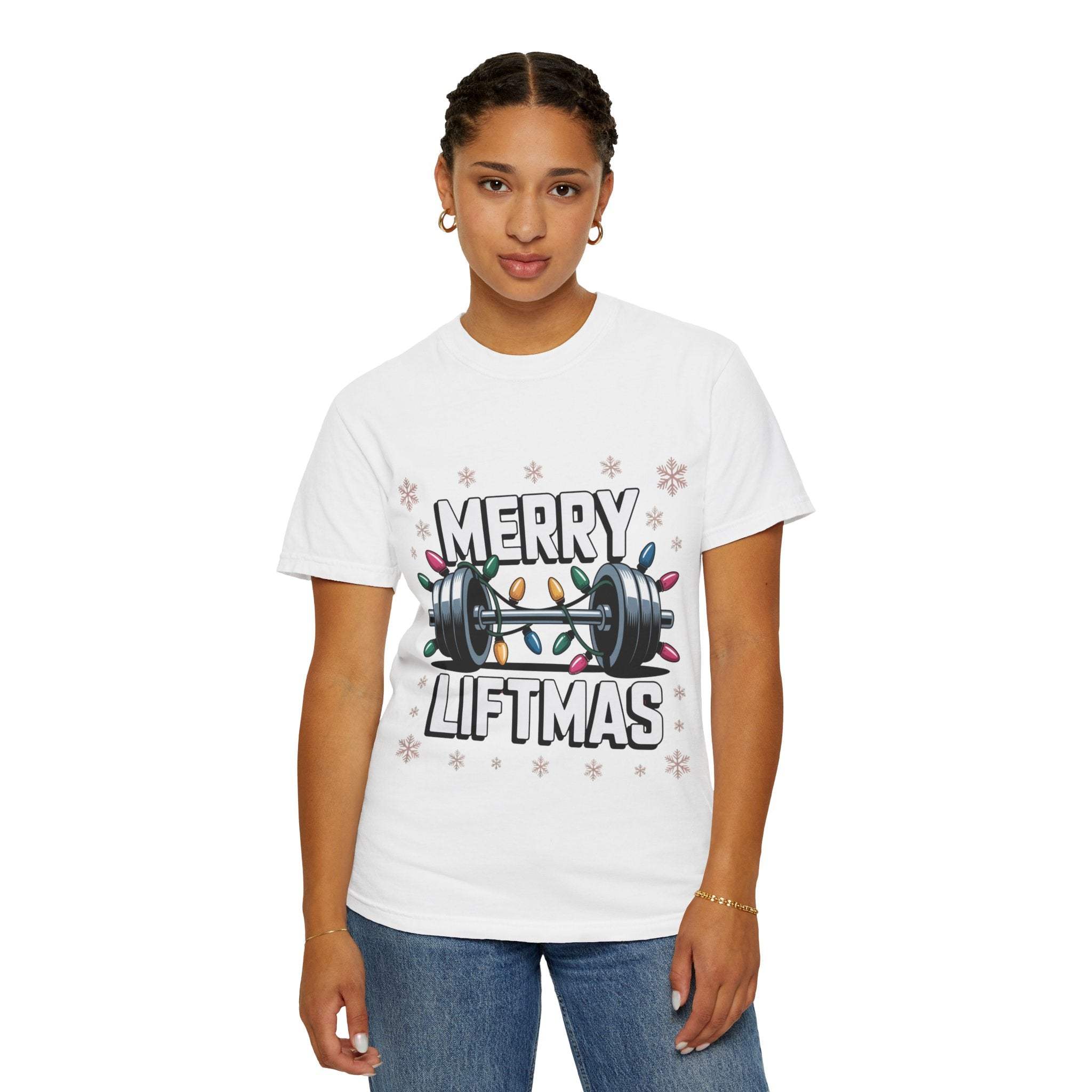 Woman wearing white Christmas Workout T-shirt with Merry Liftmas design and colorful holiday lights wrapped around a barbell