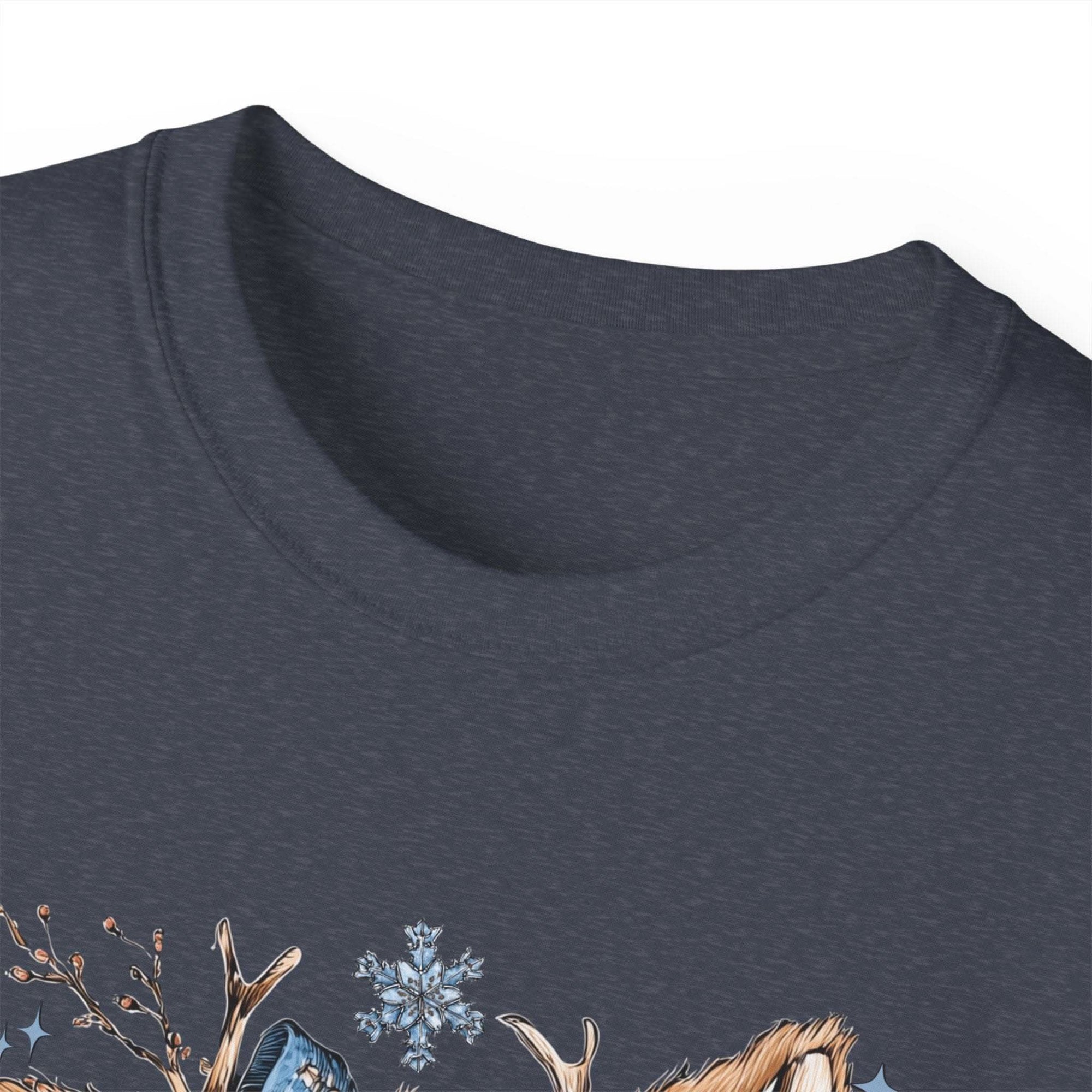 White t-shirt with retro patchwork reindeer design wearing blue scarf and surrounded by snowflakes