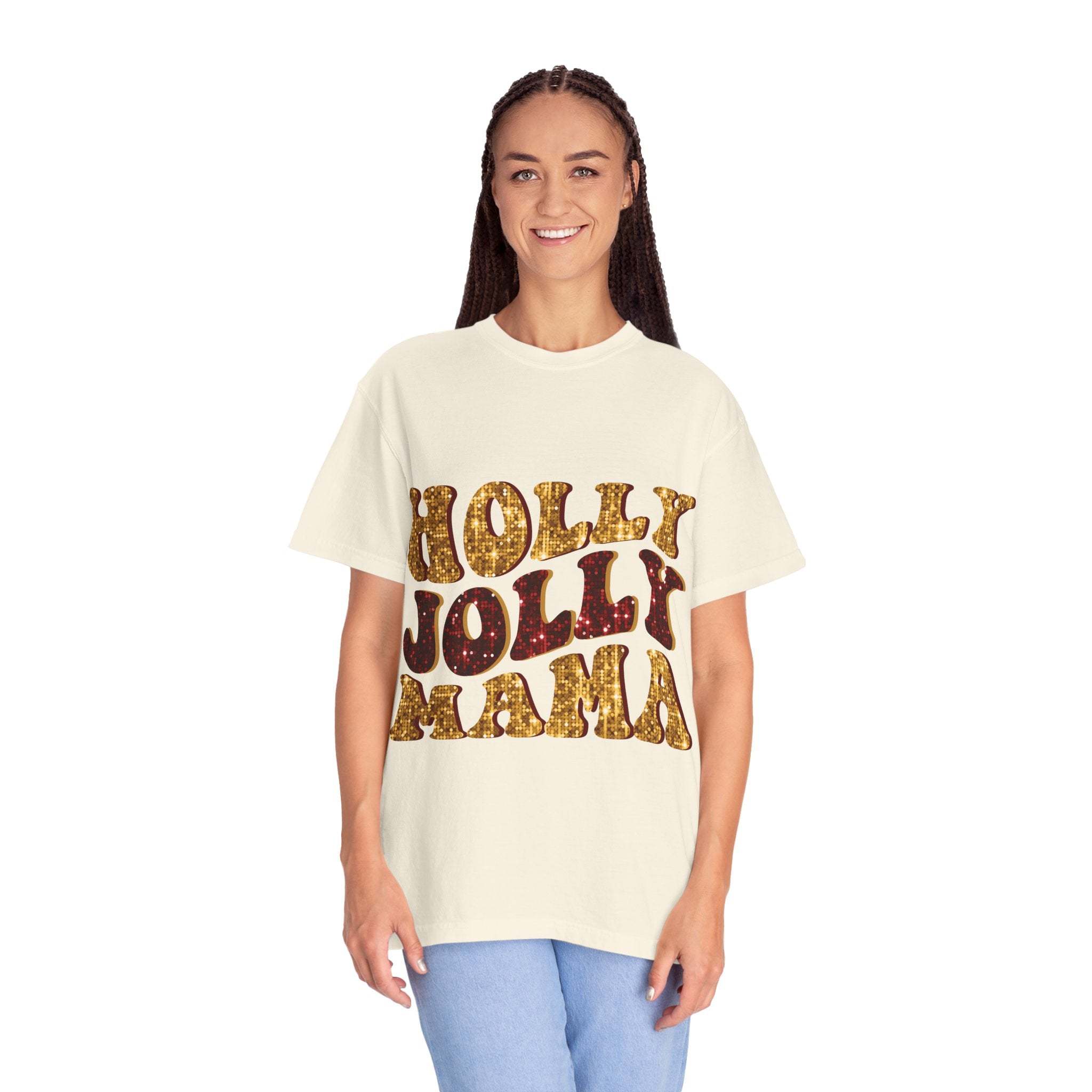 Woman wearing a white Faux Glitter Holly Jolly Mama t-shirt with gold glitter text and blue jeans