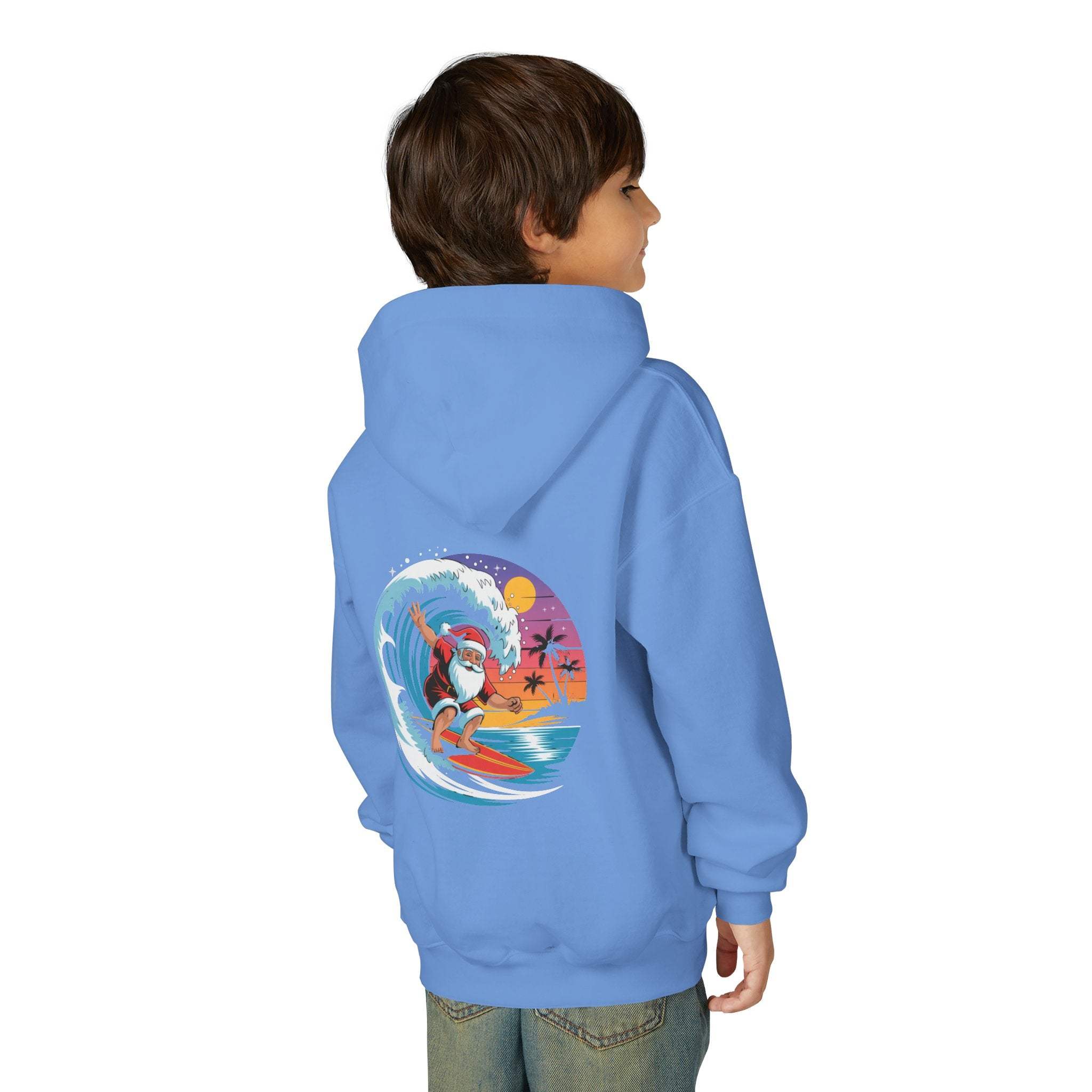Child wearing navy Surfing Santa Hoodie with Santa surfing on wave graphic on back