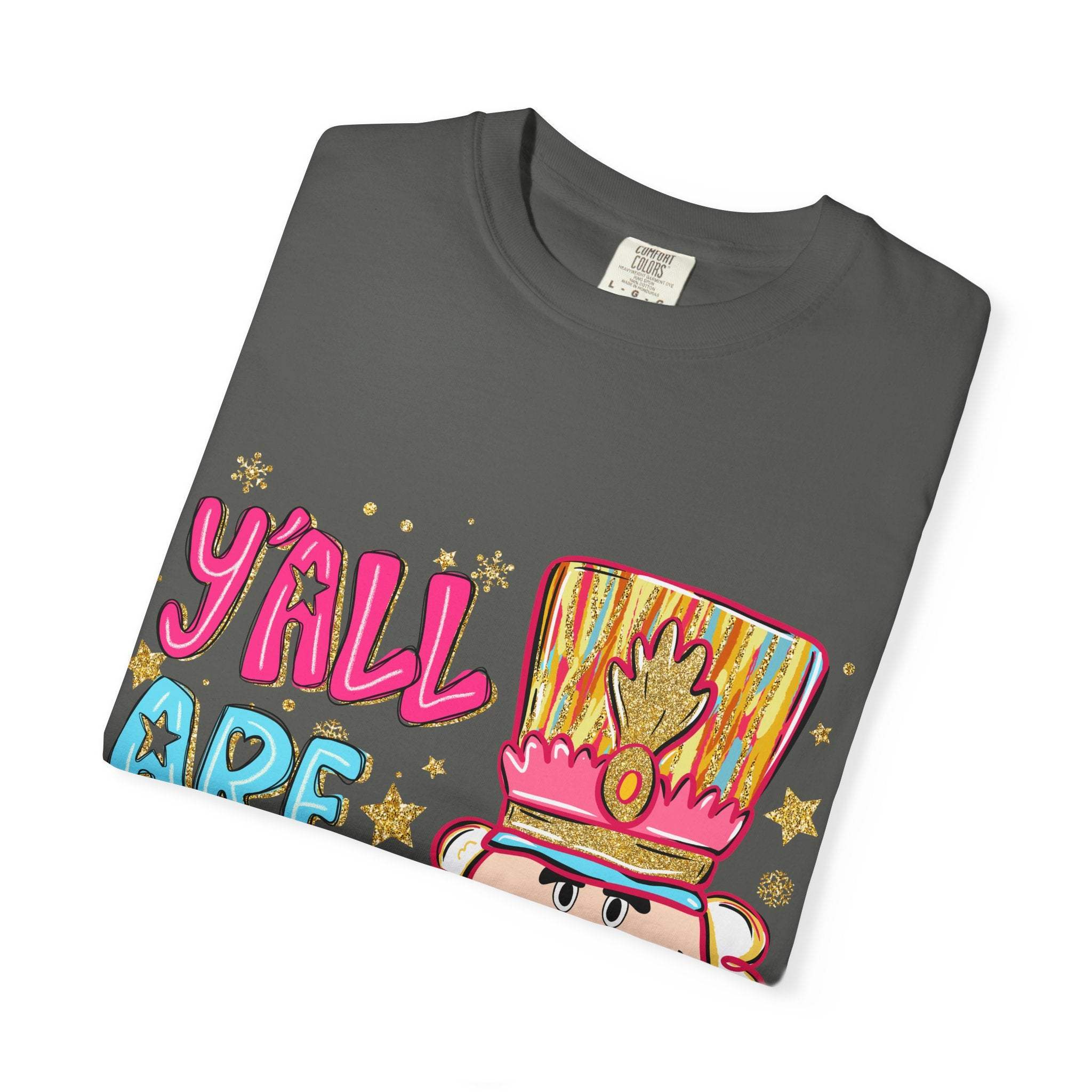 Folded dark gray T-shirt with colorful Yall Are Nuts Nutcracker graphic and festive design