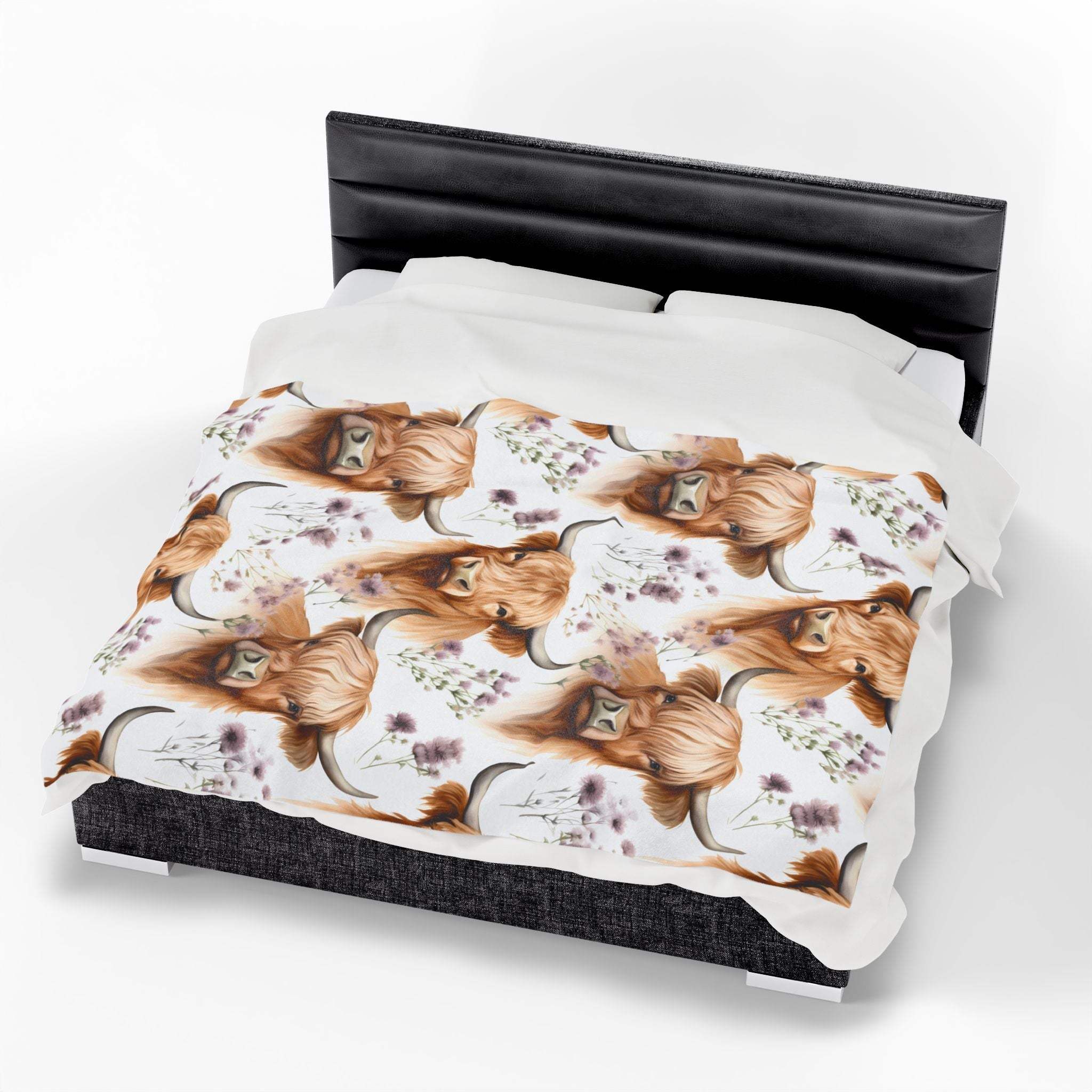 Plush blanket with floral highland cow design on bed, cozy rustic decor fleece throw