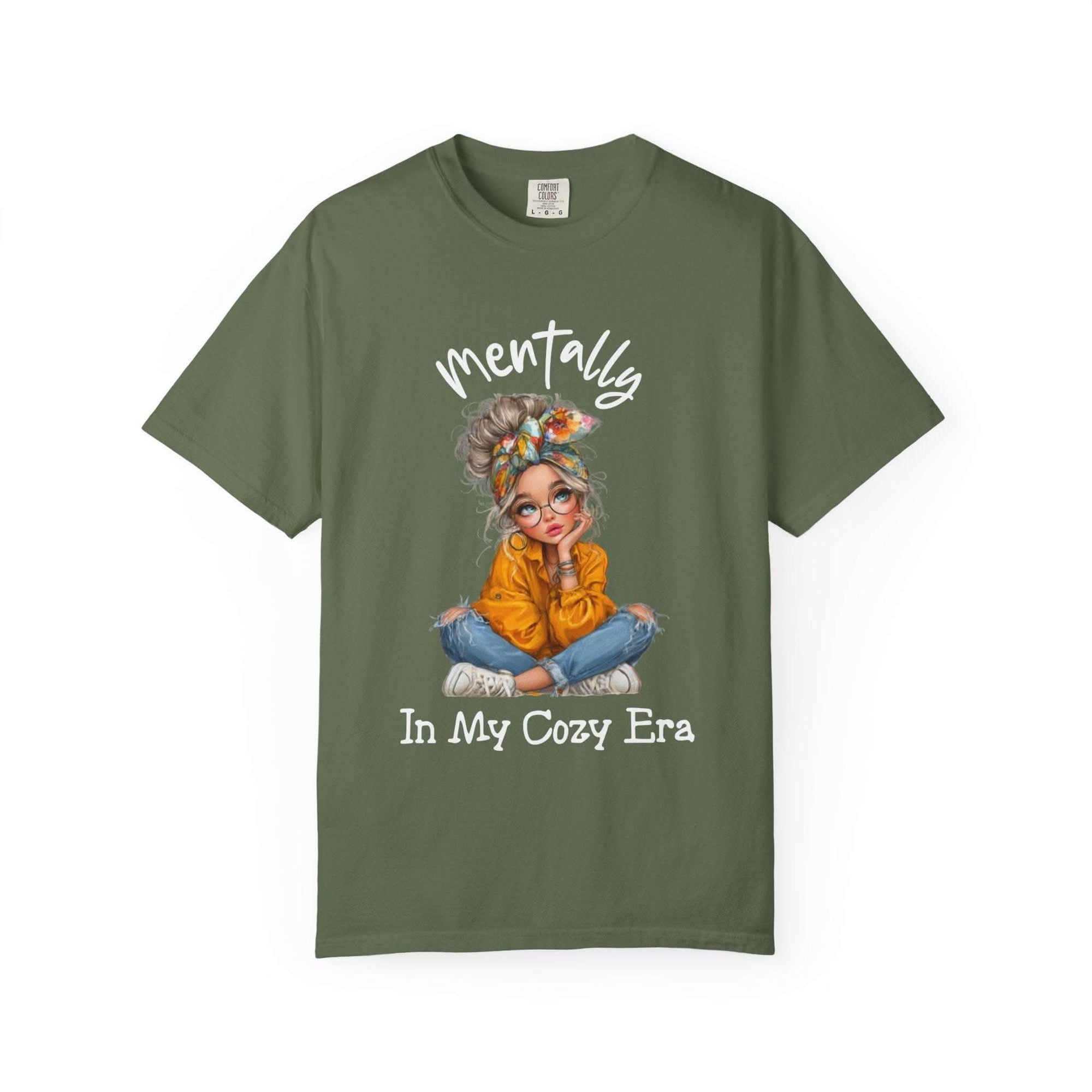 Mentally in my Cozy Era green t-shirt with graphic of a girl sitting cross-legged wearing glasses and a headband