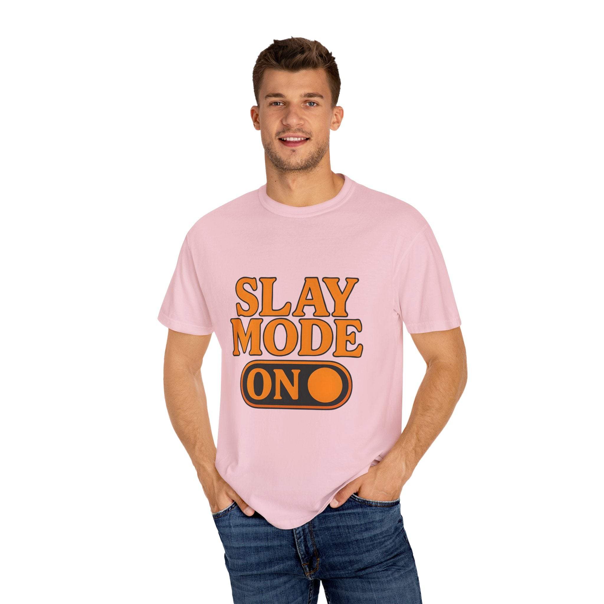 Man wearing pink garment-dyed tee with "Slay Mode On" text and orange design