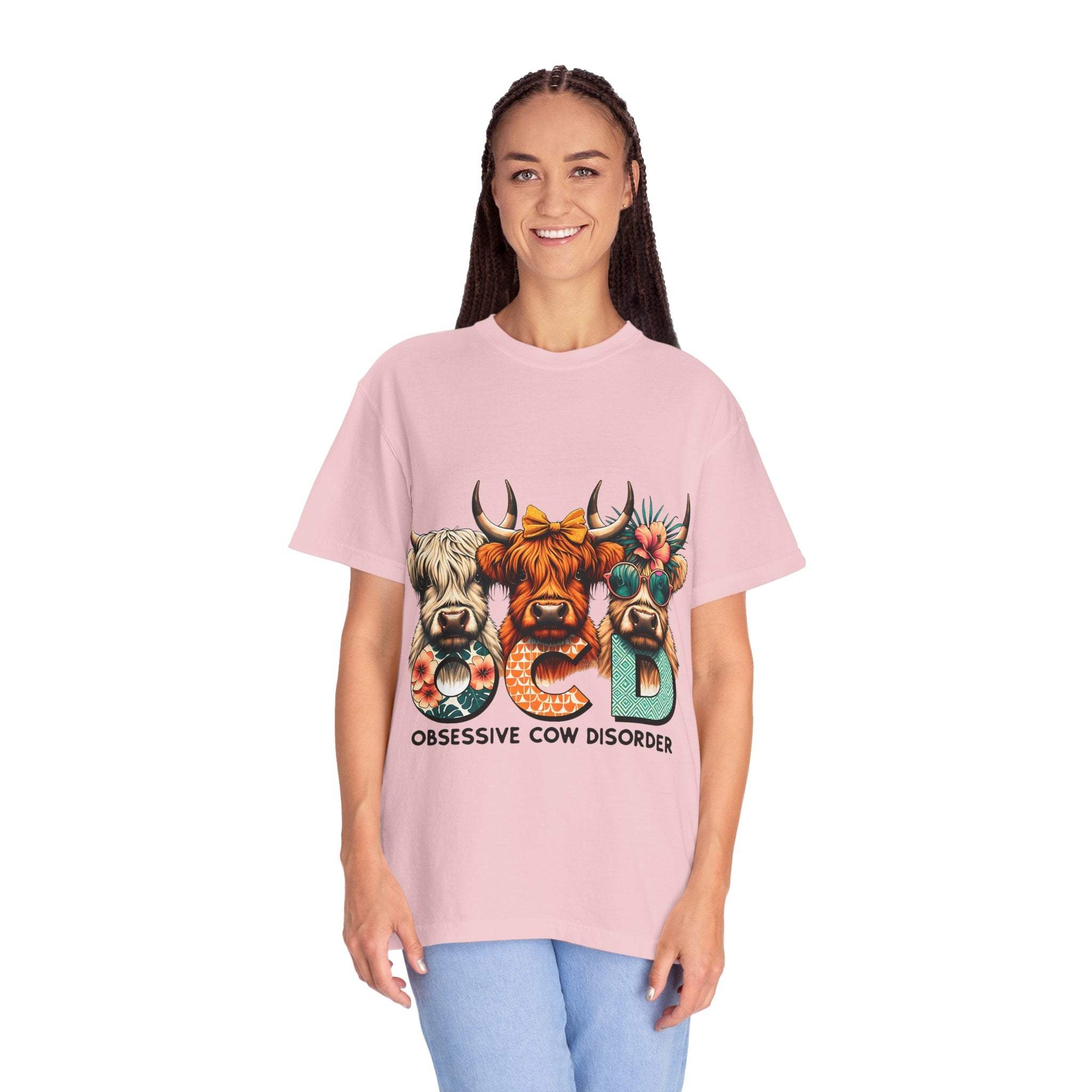 Woman wearing a pink Funny OCD Obsessive Cow Disorder graphic T-shirt with cow illustrations