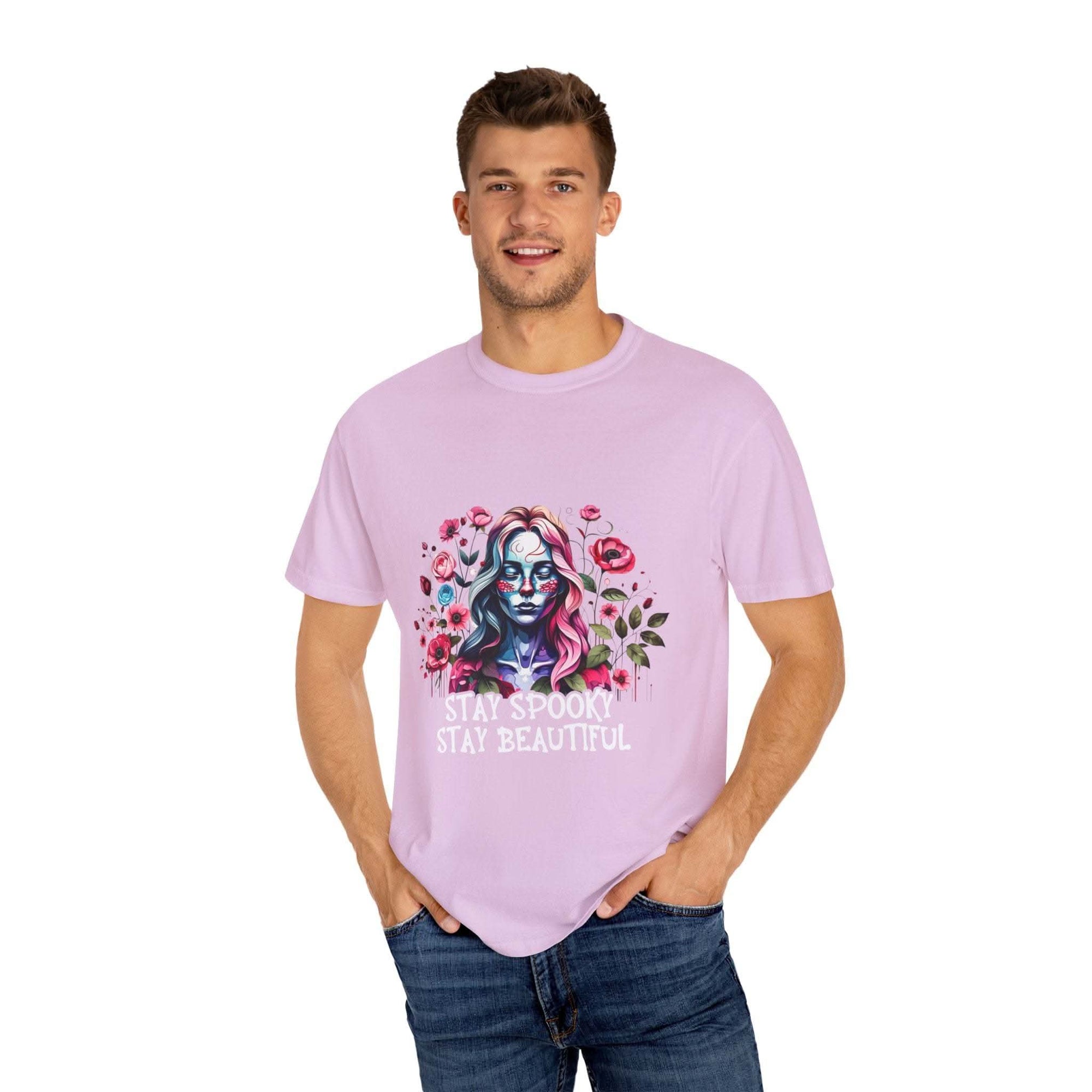 Man wearing soft everyday tee with elegant floral skeleton print and text stay spooky stay beautiful