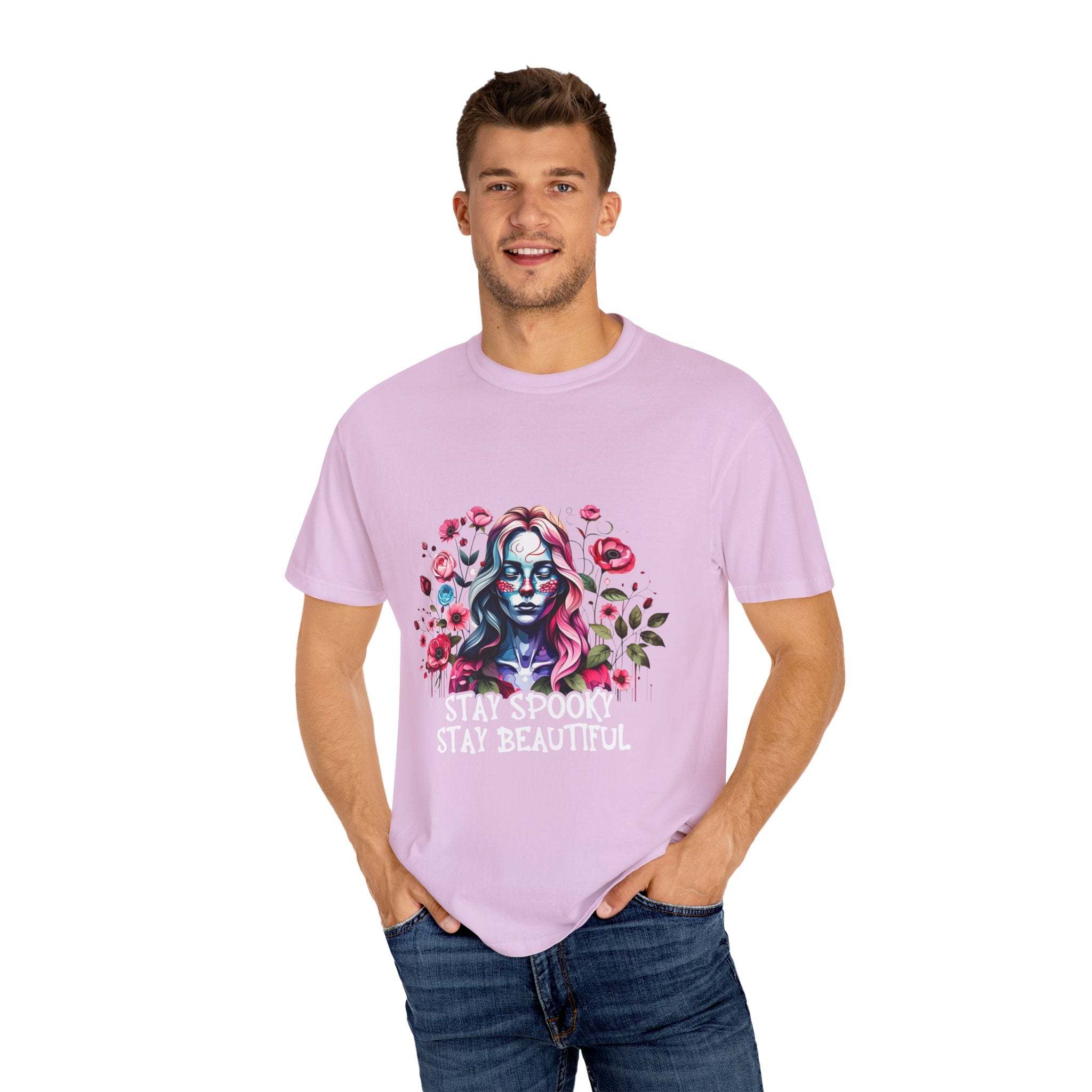 Man wearing soft everyday tee with elegant floral skeleton print and text stay spooky stay beautiful