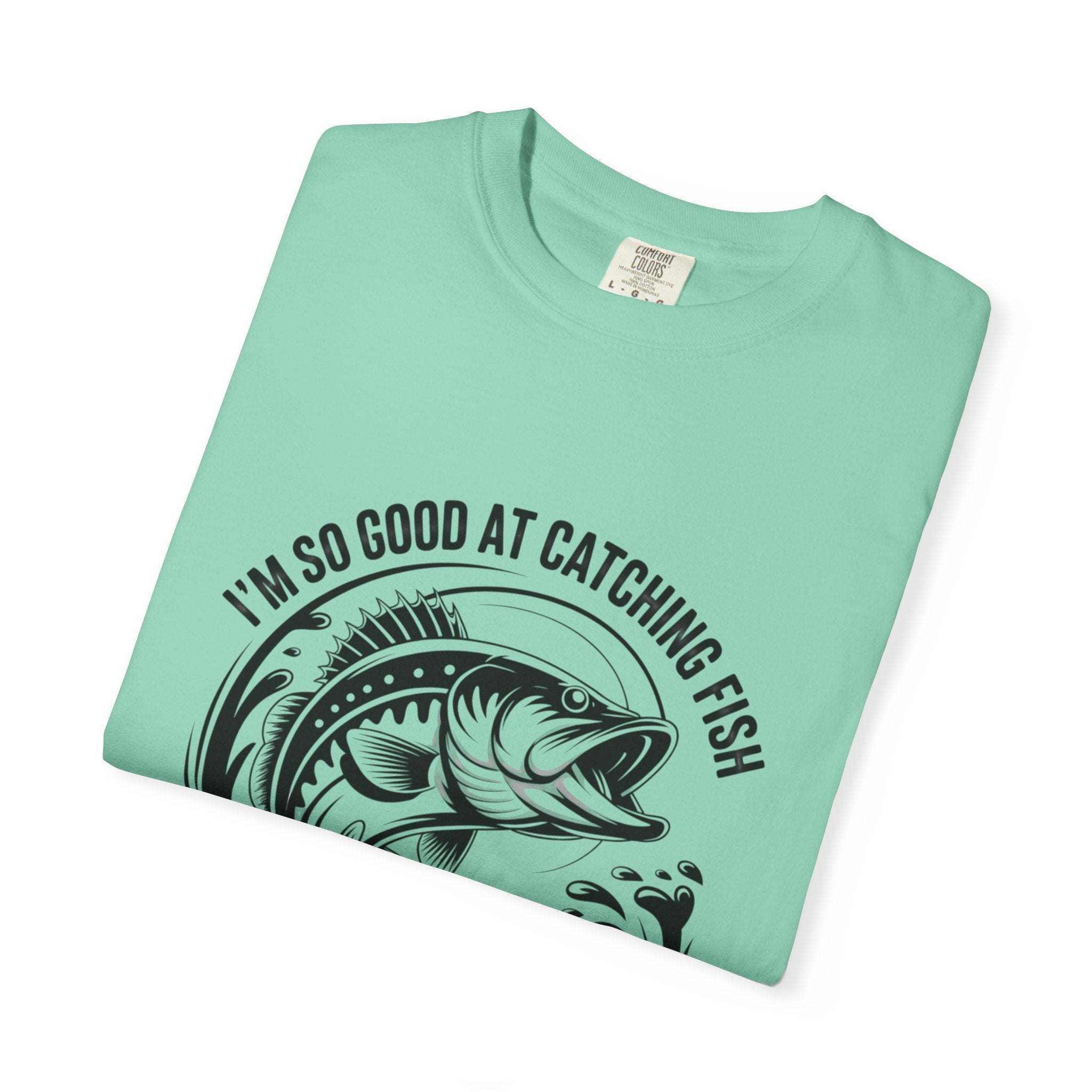 Fishing T-Shirt with humorous “So Good At Catching Fish That The Fish Tell Stories About Me” phrase on relaxed-fit cotton tee