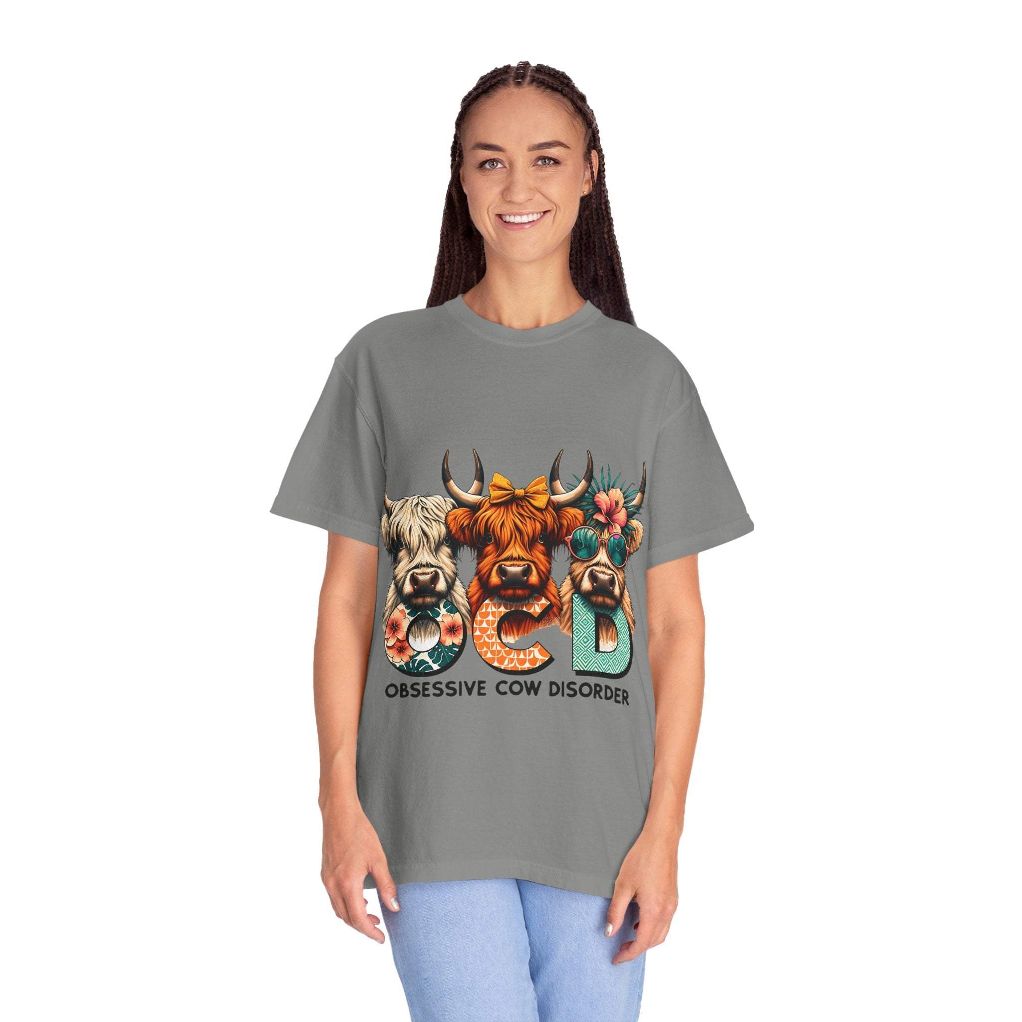 Woman wearing funny OCD Obsessive Cow Disorder graphic T-shirt with three cows and colorful text on gray background