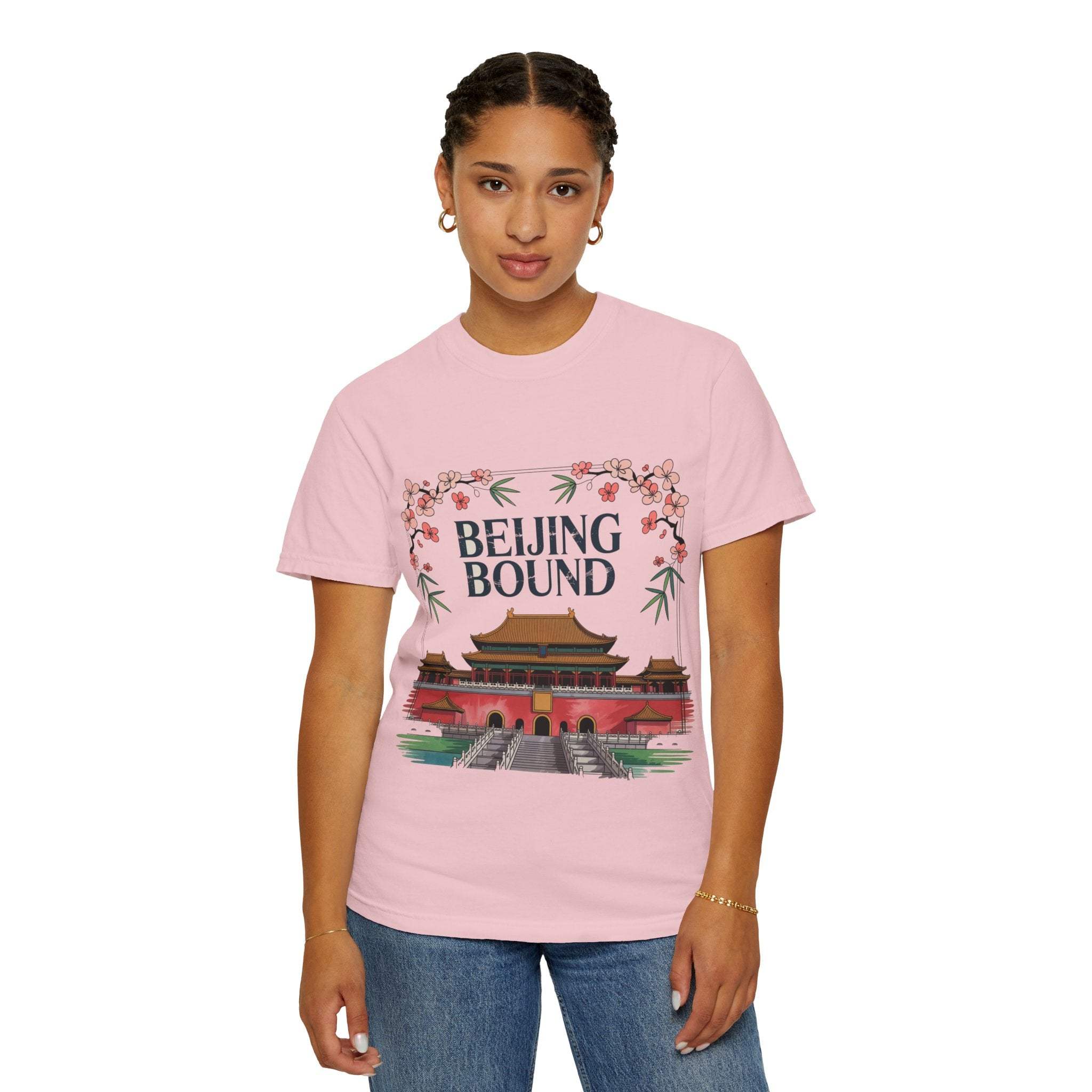 Woman wearing pink Beijing Bound Travel T-shirt featuring temple design and floral accents