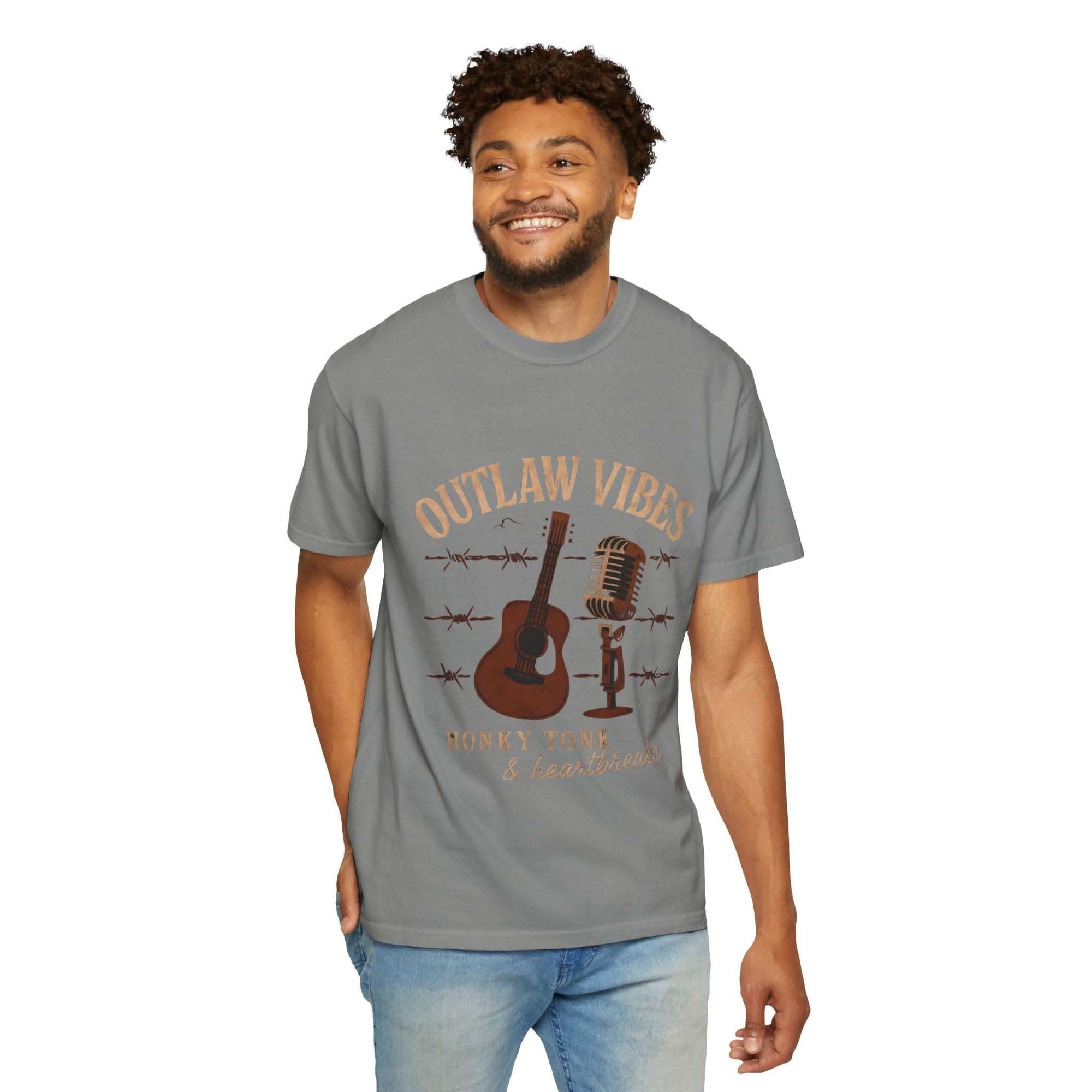 Man wearing a gray t-shirt with 'Outlaw Vibes' graphic design on a white background