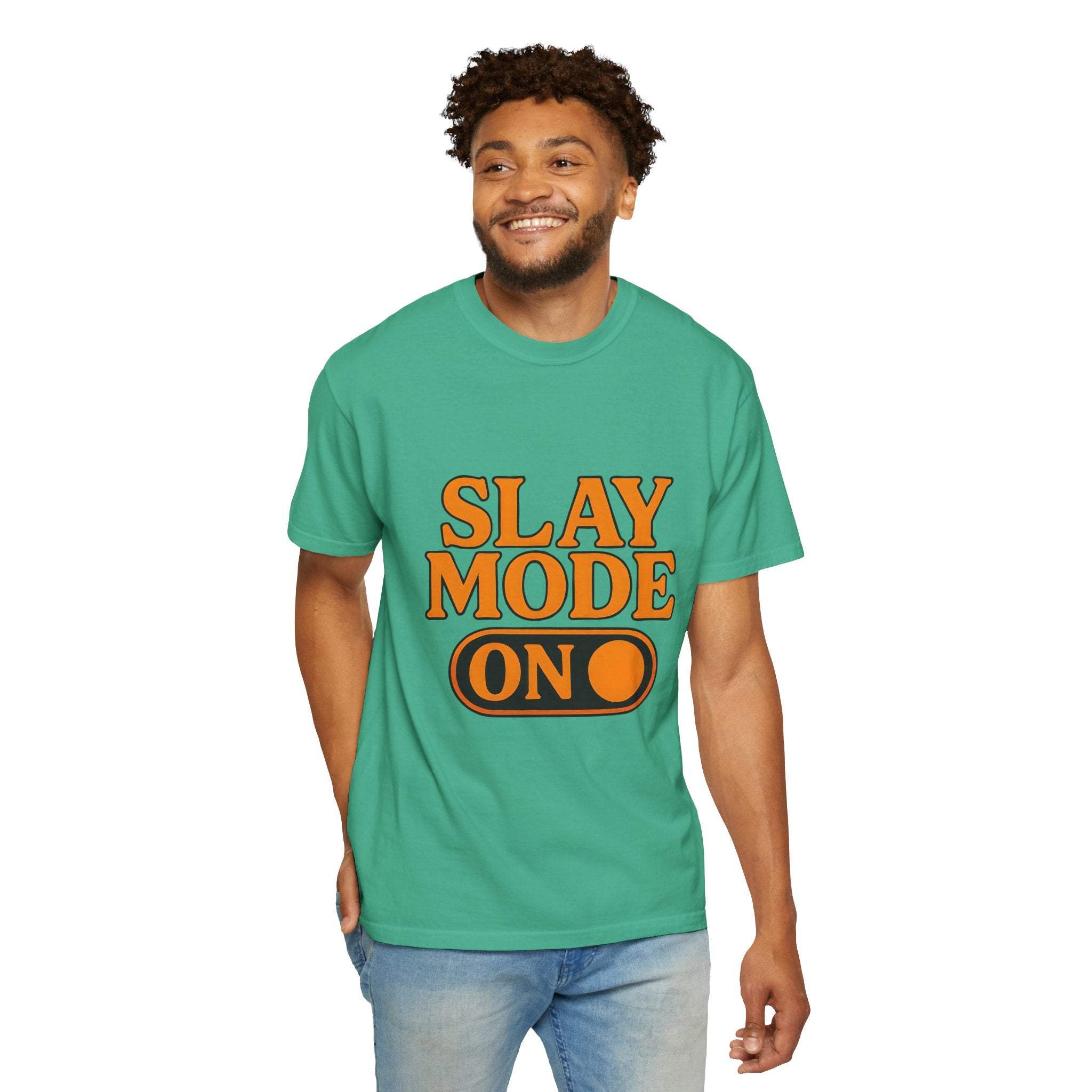 Man wearing green garment-dyed tee with "SLAY MODE ON" text in orange