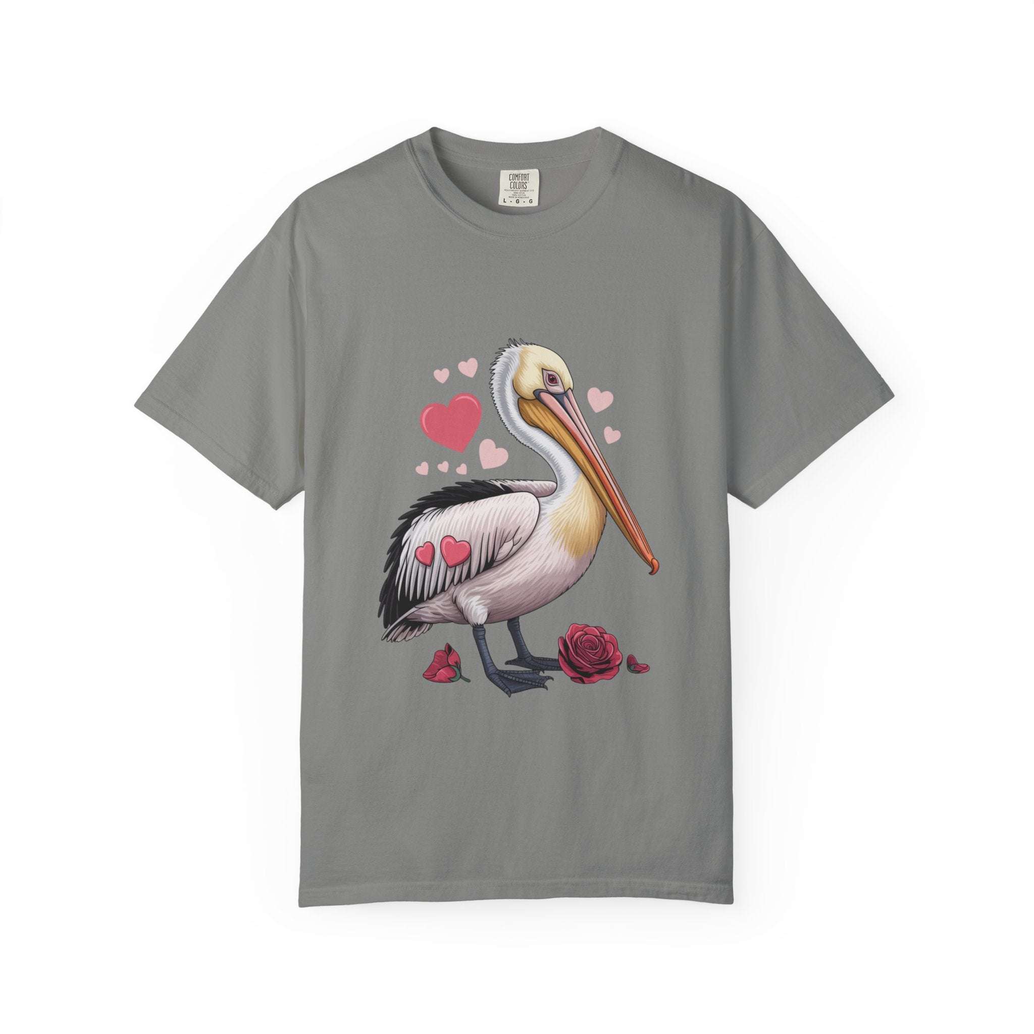 Valentine Pelican Hearts T-Shirt with pelican carrying heart on sunlit shoreline in soft garment-dyed cotton