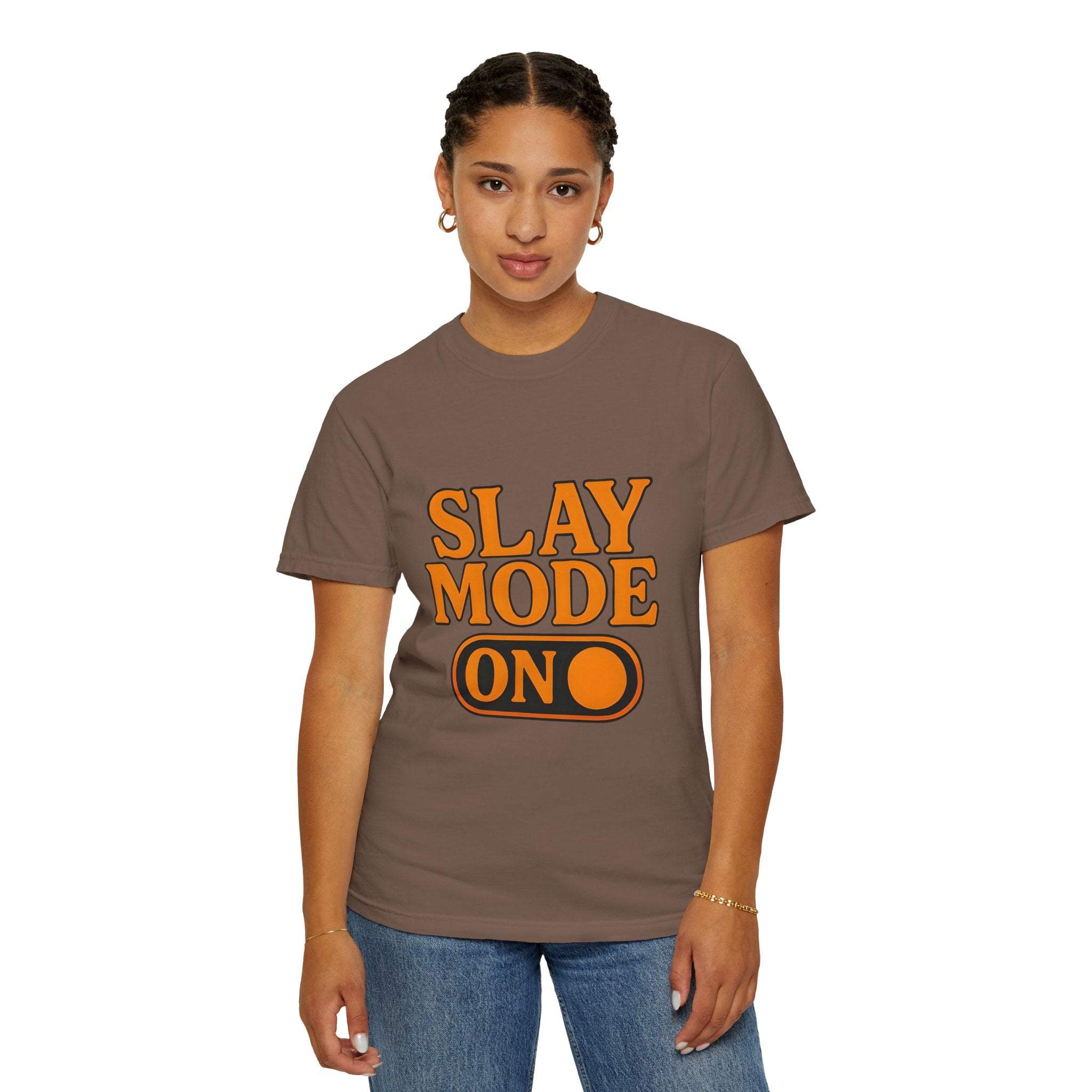 Woman wearing brown garment-dyed tee with orange "Slay Mode On" text, casual fit, cotton material.