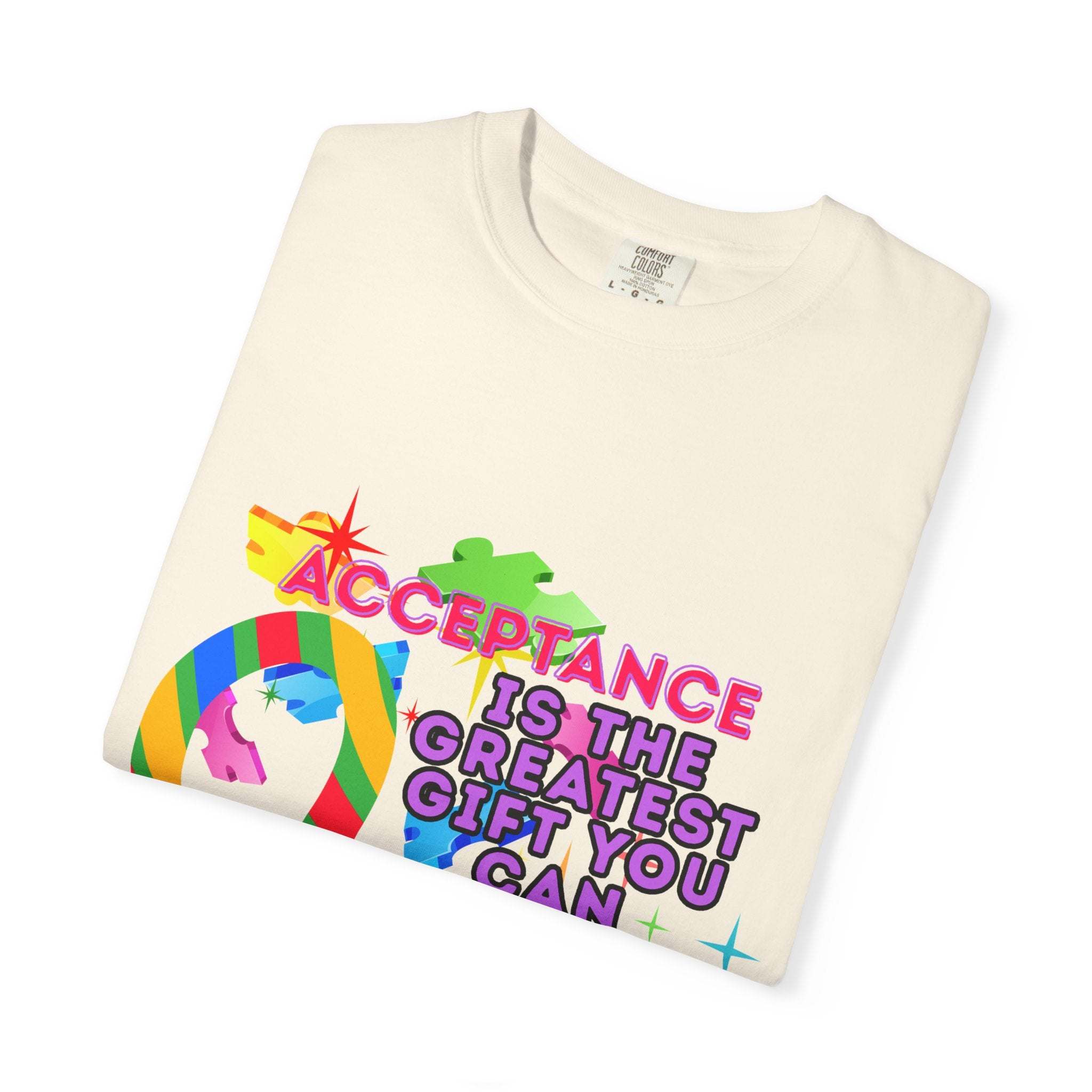 Folded garment-dyed T-shirt with Autism Acceptance design and colorful puzzle pieces promoting inclusivity and support