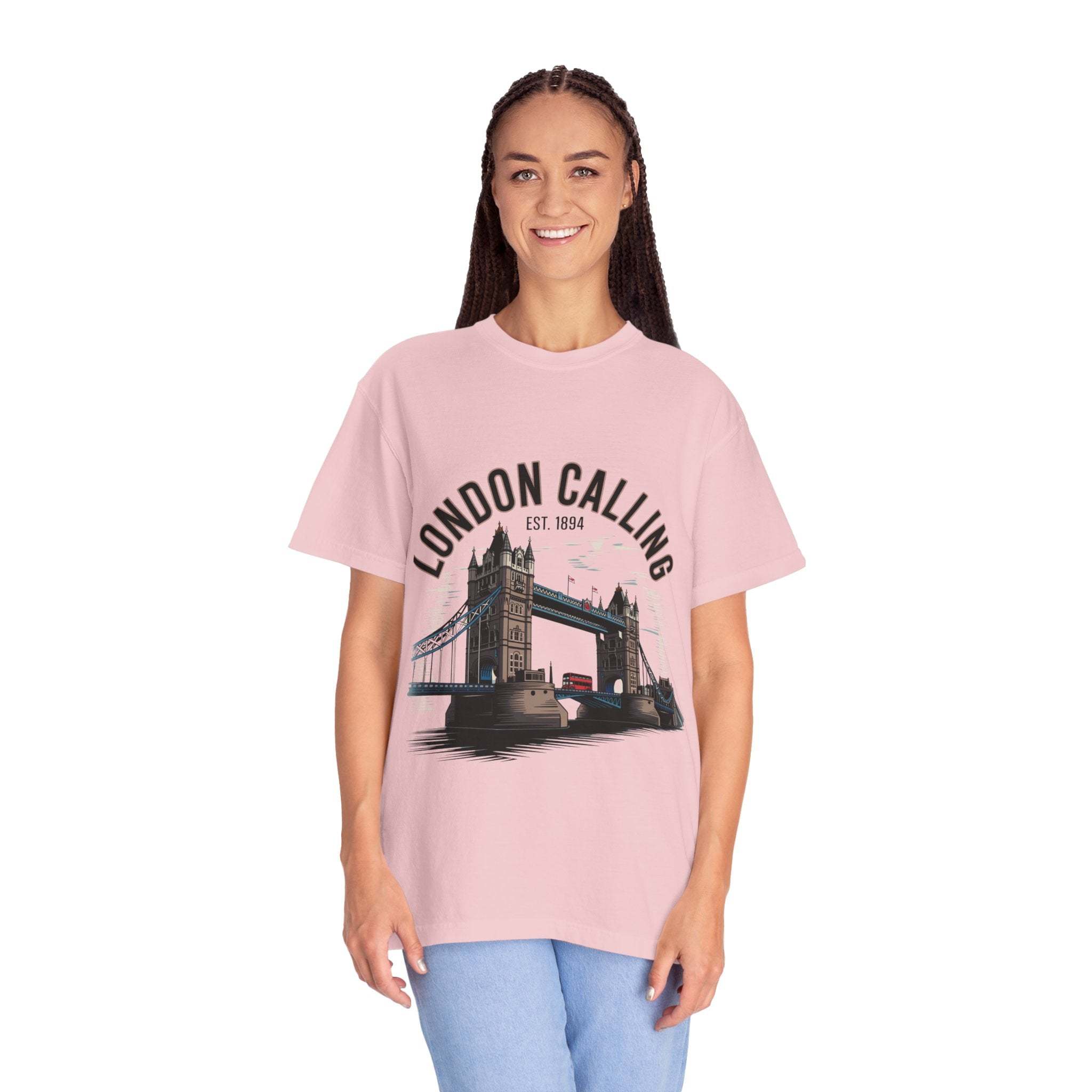 Woman wearing pink London Calling Travel T-shirt with Tower Bridge graphic, unisex garment-dyed cotton shirt