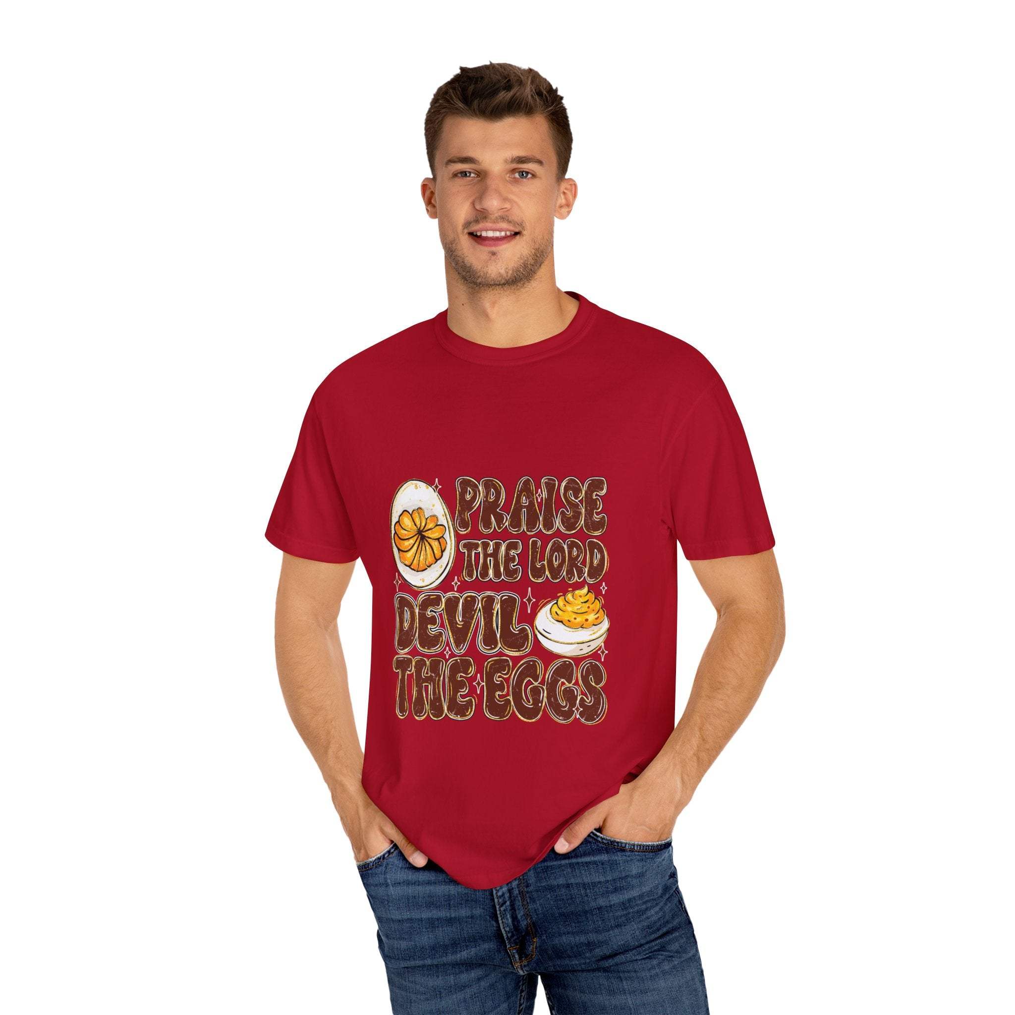 White cotton t-shirt featuring 'Praise the Lord, Devil the Eggs' design, perfect for Easter and Christian apparel.