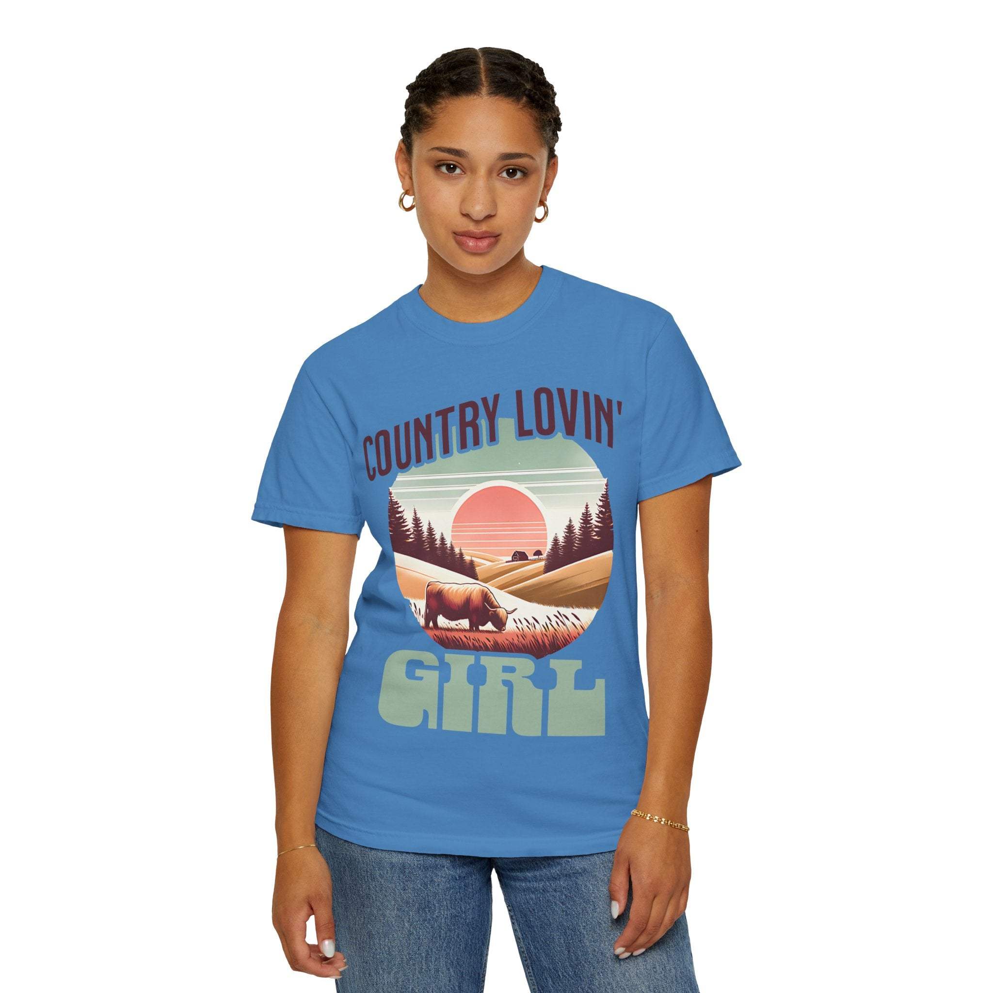 Woman wearing blue Country Lovin Girl T-shirt with vintage rural sunset graphic
