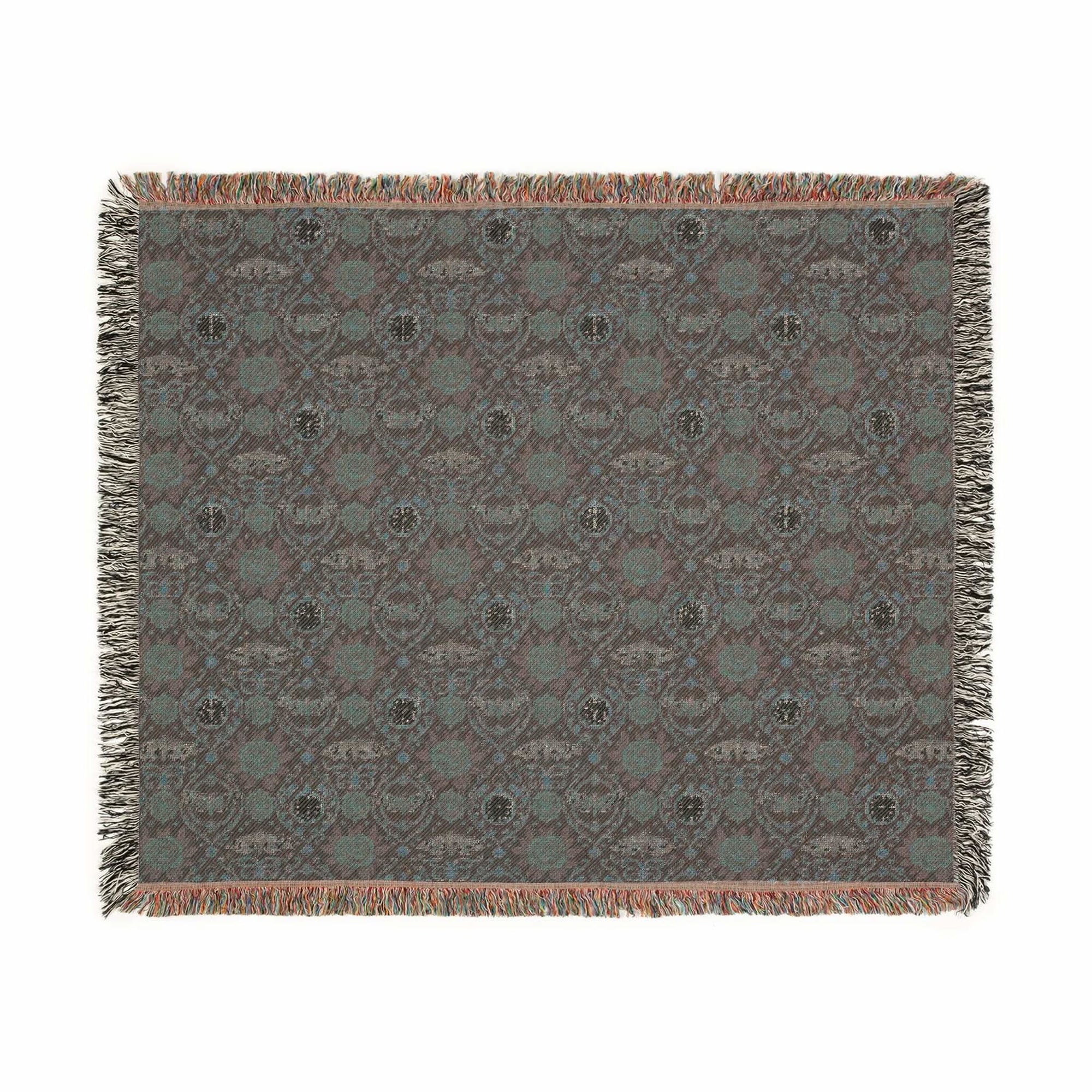 Victorian Gothmas Woven Blanket with candlelight hues and colorful fringed edges draped over dark velvet