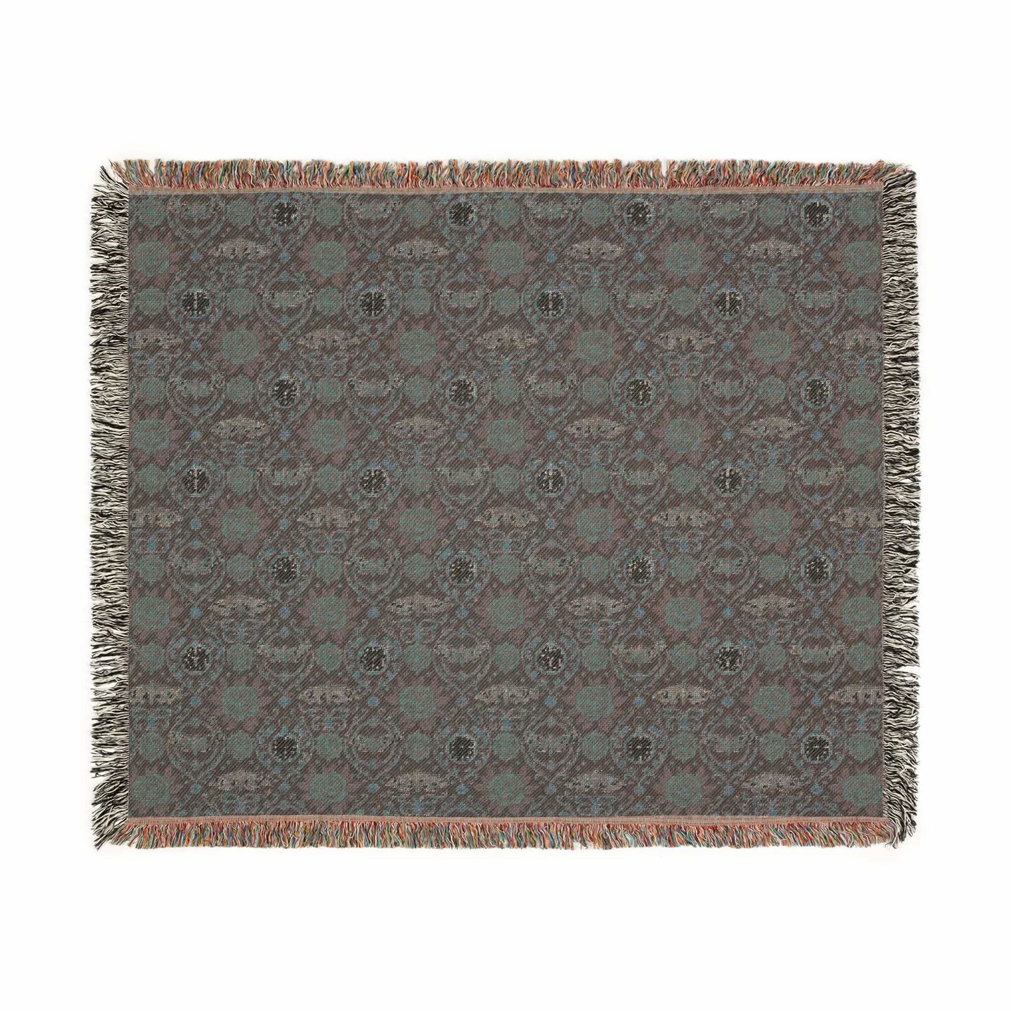 Victorian Gothmas Woven Blanket with candlelight hues and colorful fringed edges draped over dark velvet