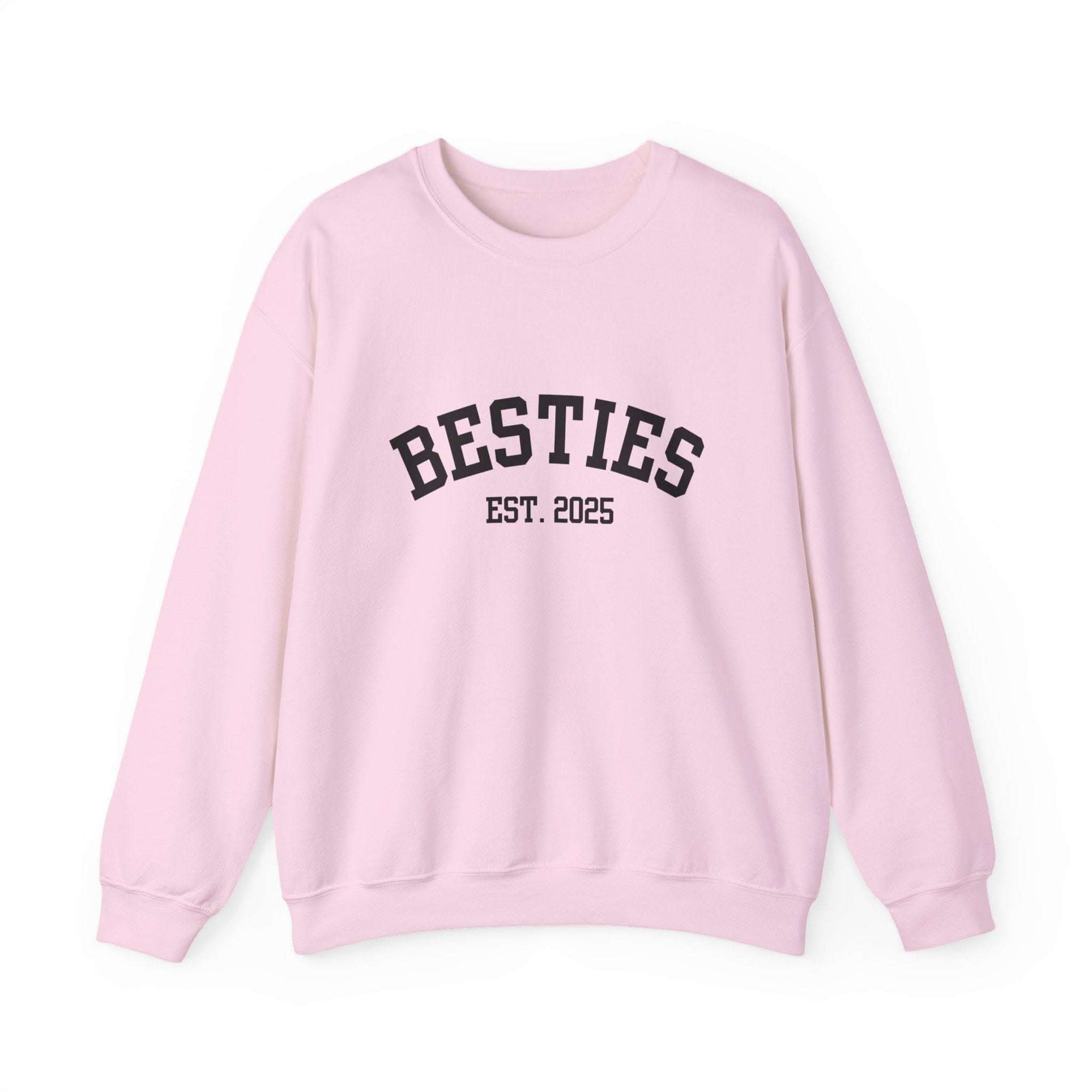 Pink sweatshirt with 'BESTIES EST. 2025' text on a white background