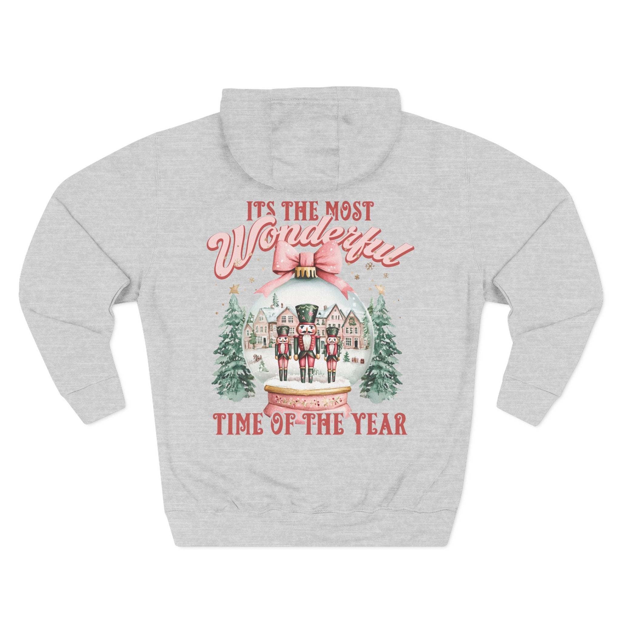 Cozy fleece hoodie with vintage pink snow globe and nutcracker design for winter comfort