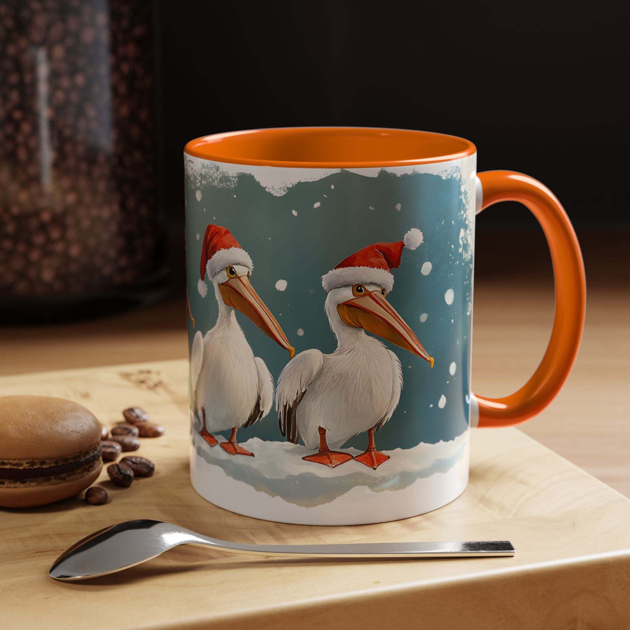 Mug with Christmas-themed design of pelicans wearing Santa hats on a table with coffee beans and a spoon.