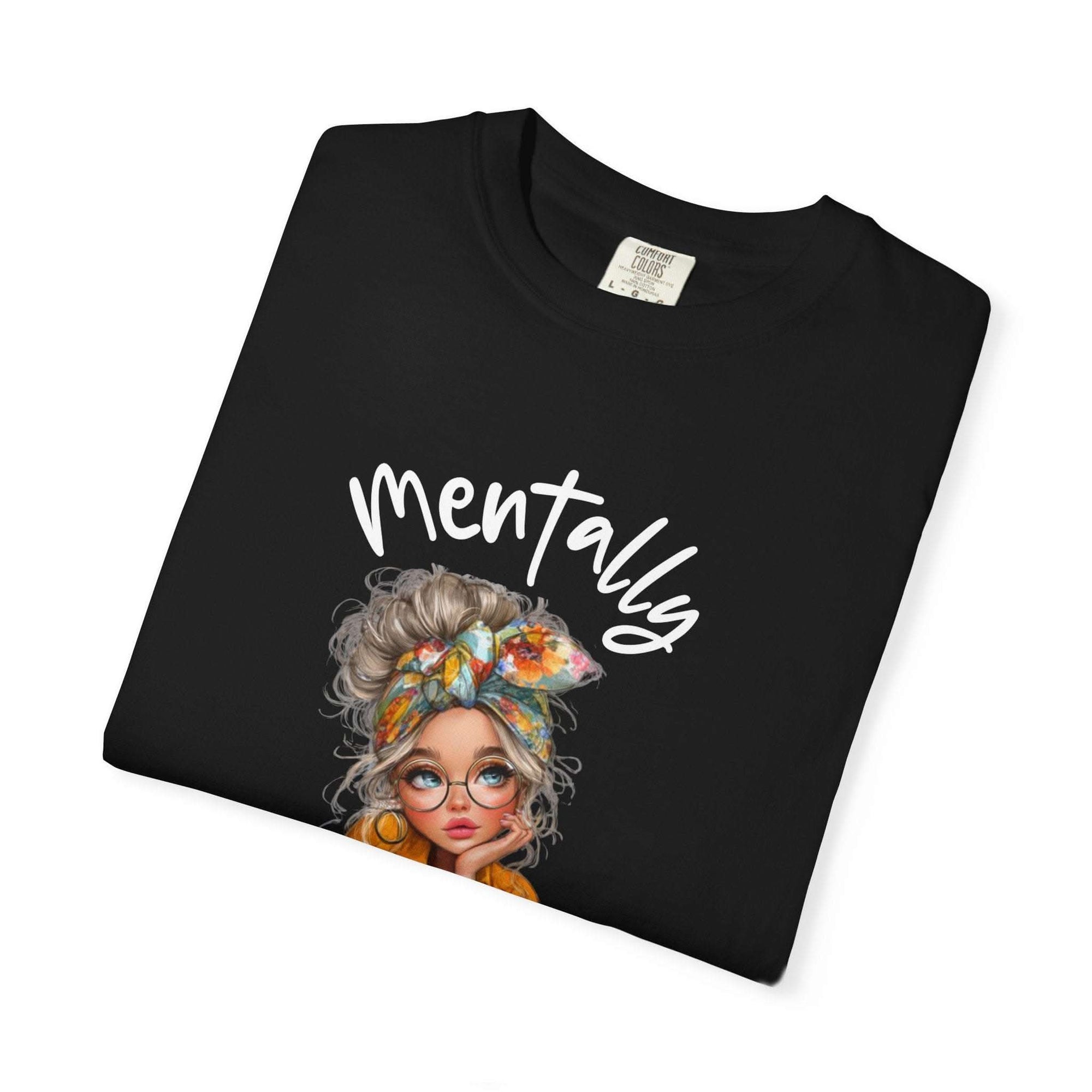 Black t-shirt with a graphic of a woman's face and the word 'Mentally' on a white background