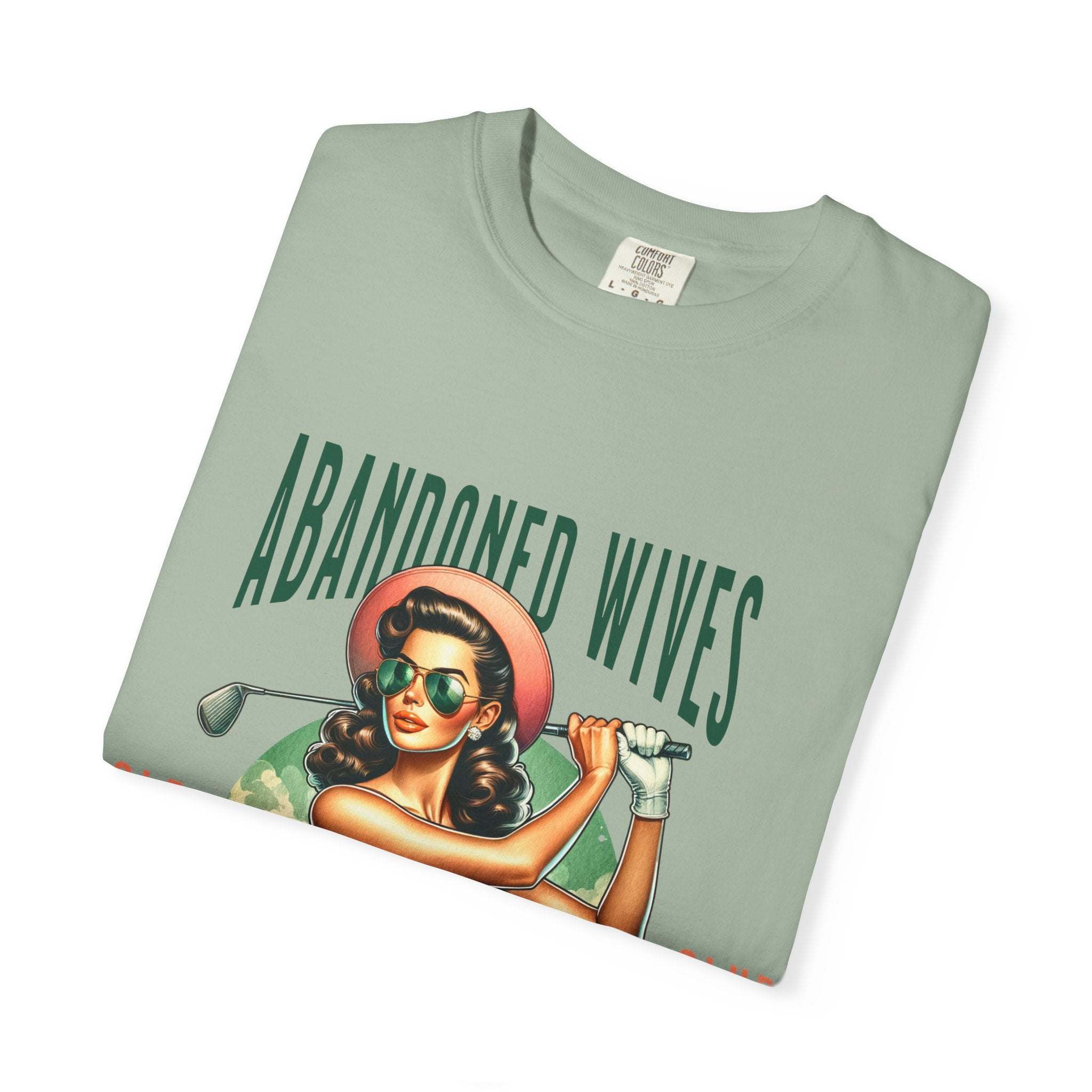 Vintage unisex t-shirt with humorous Abandoned Wives Golf Club design, soft garment-dyed cotton, available in multiple sizes and colors