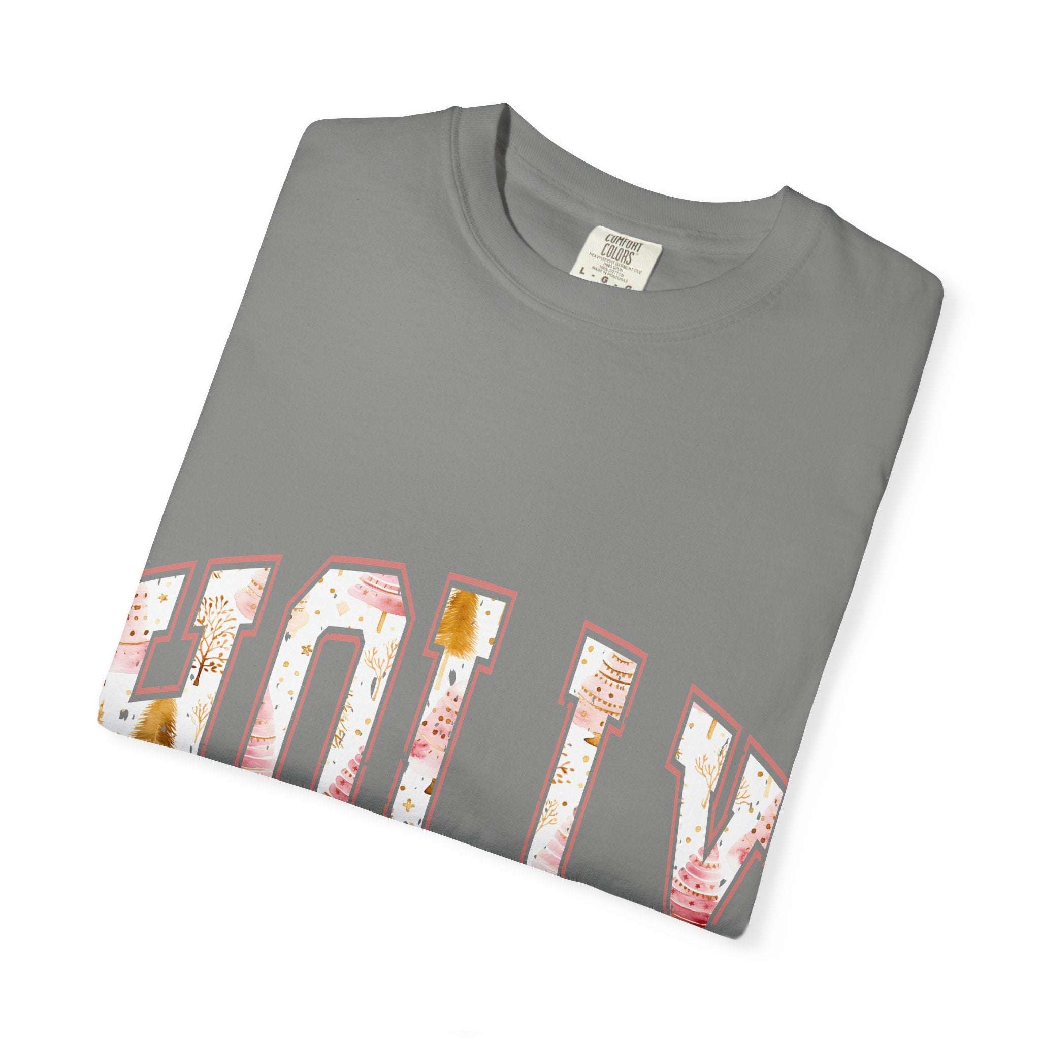 Folded grey Varsity Holly Jolly T-shirt with festive lettering in white and pink holiday designs