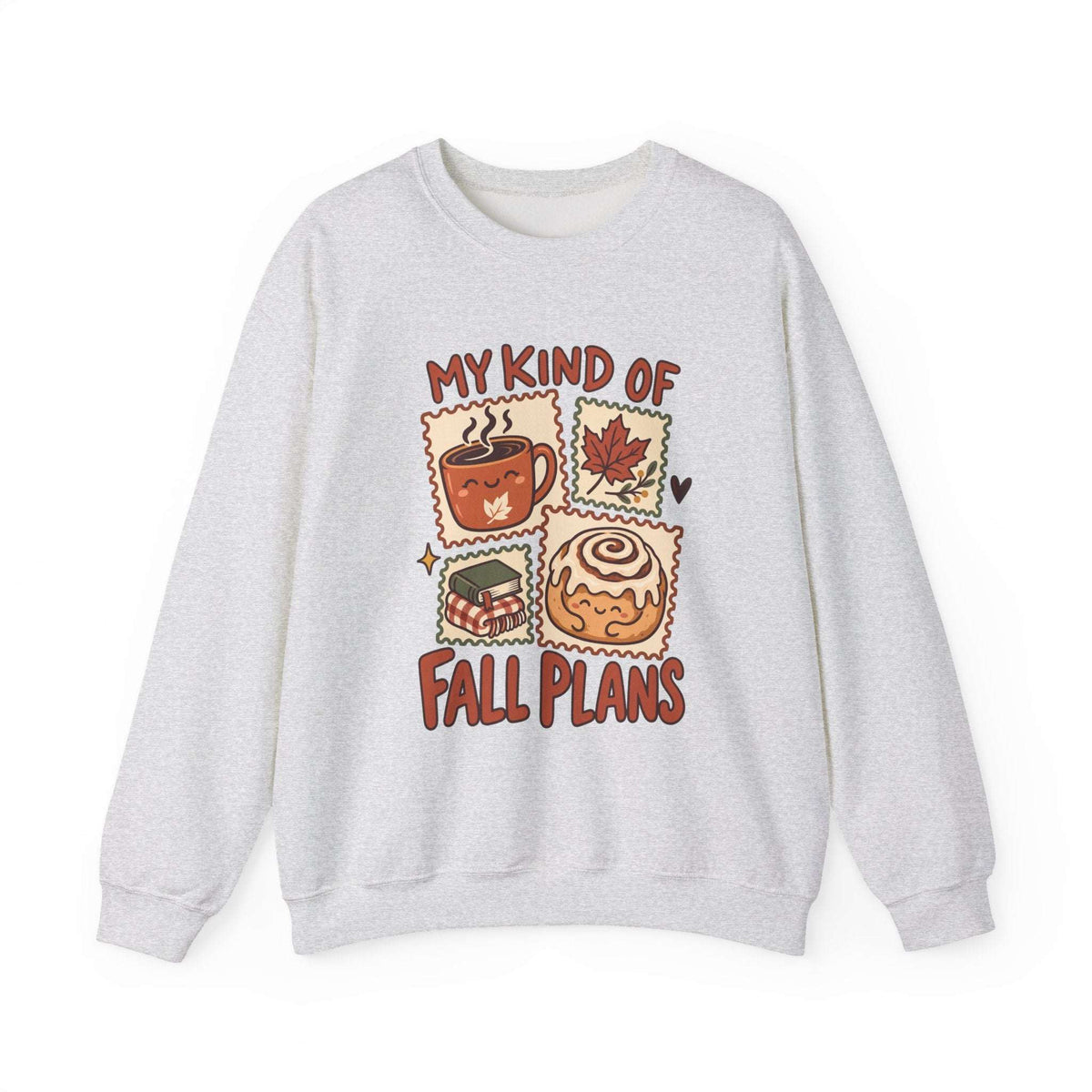 A light gray crewneck sweatshirt featuring a colorful graphic print on the front with the text 'MY KIND OF FALL PLANS' and four autumn-themed illustrations including a hot cocoa cup, a maple leaf, a sandwich, and a cinnamon roll.