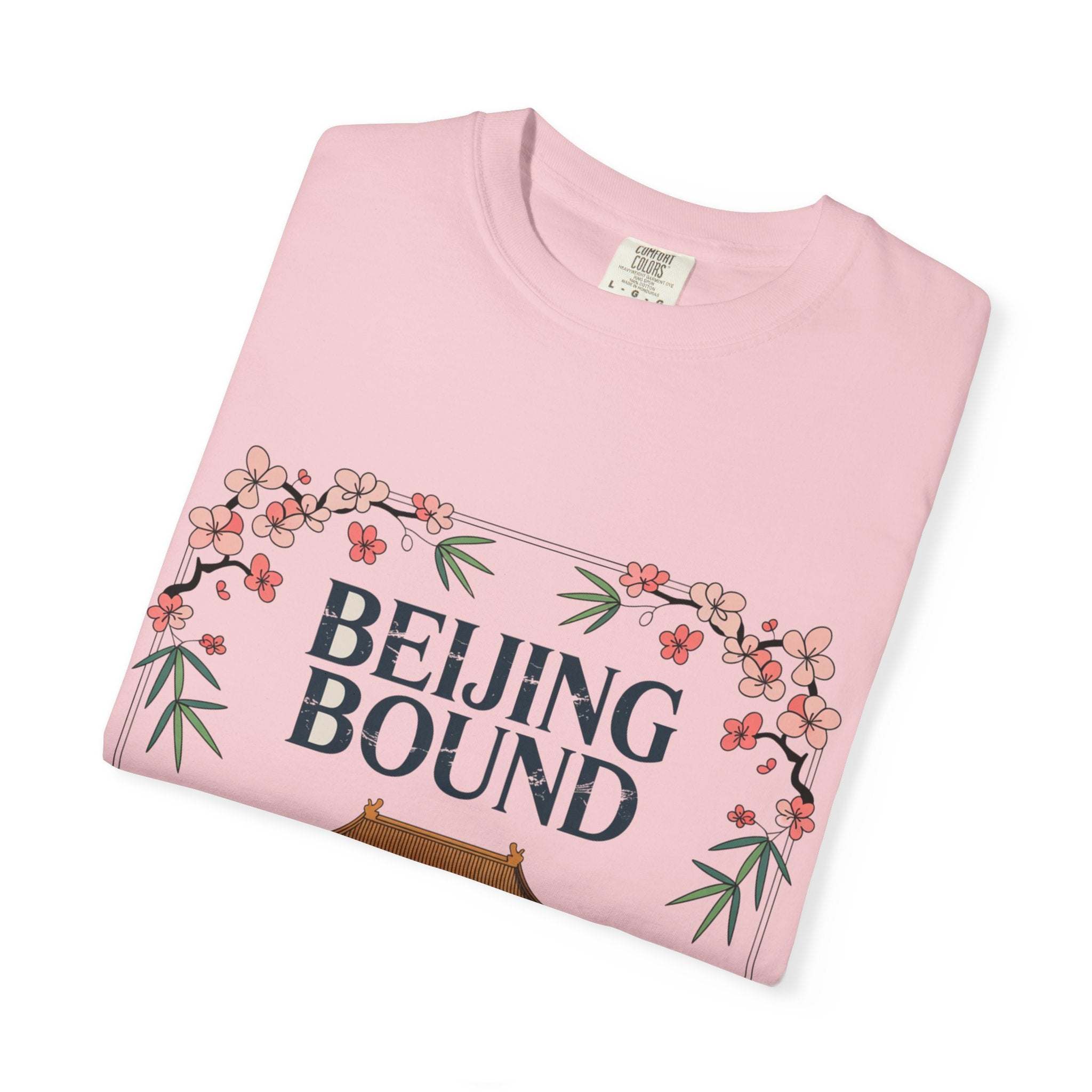 Pink travel t-shirt with Beijing Bound design and floral accents, soft garment-dyed cotton for travelers