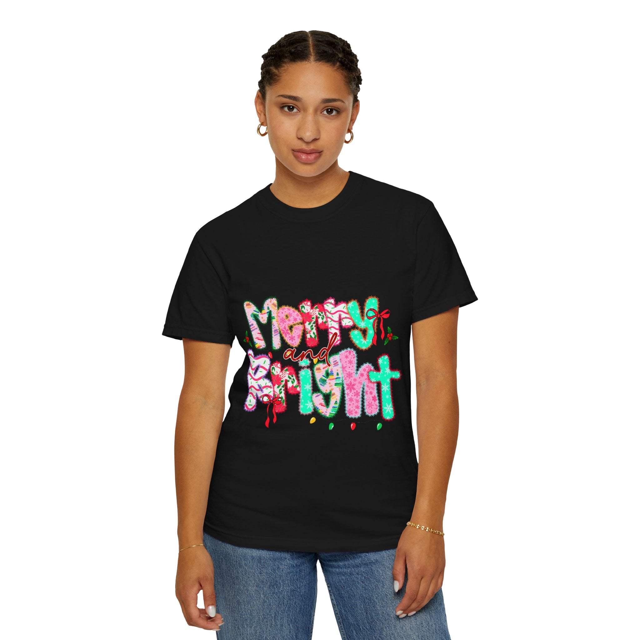 Woman wearing black Merry and Bright T-shirt with colorful holiday design and casual jeans