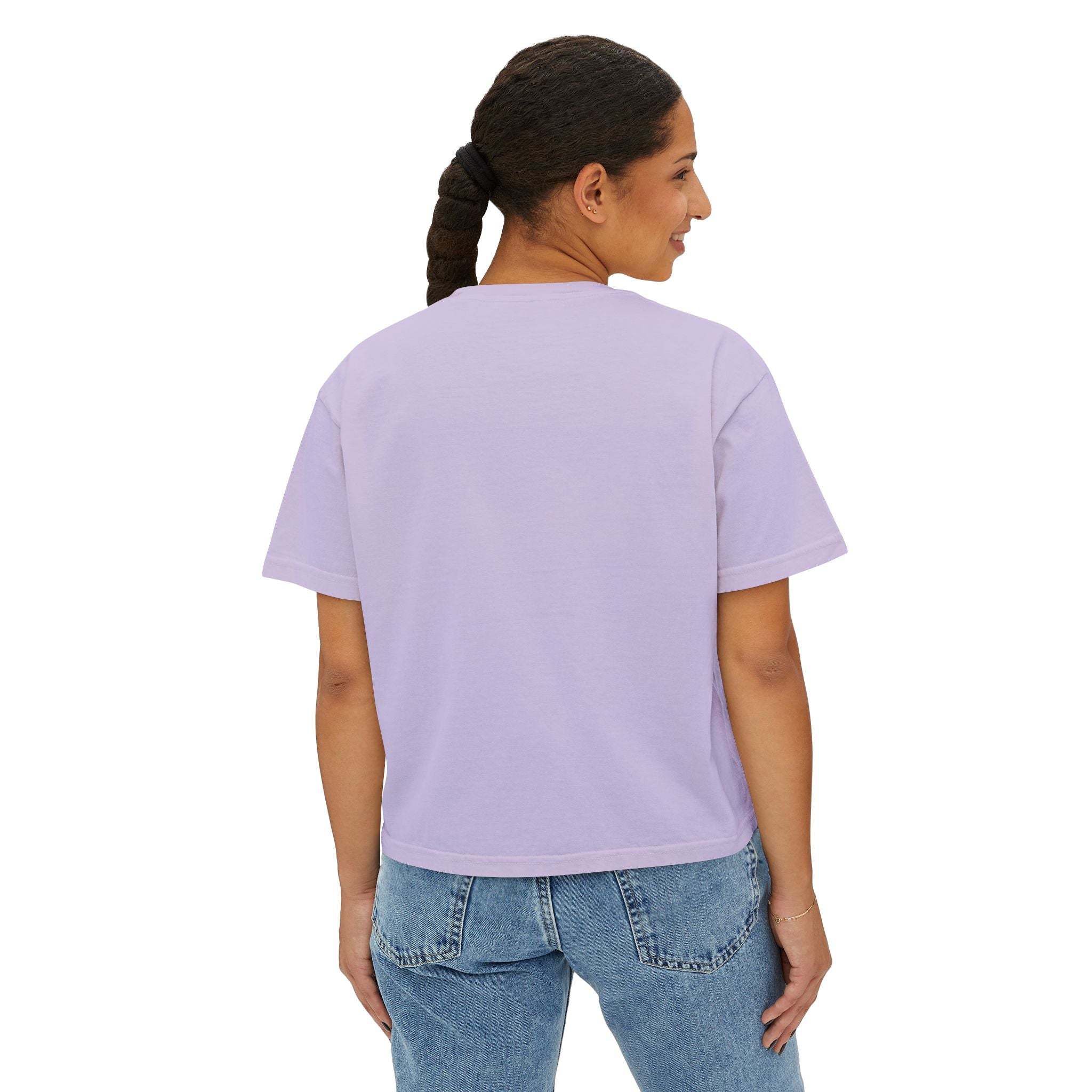 Woman wearing lilac boxy tee with short sleeves and crew neck, casual fit with slightly cropped length, paired with blue jeans, back view