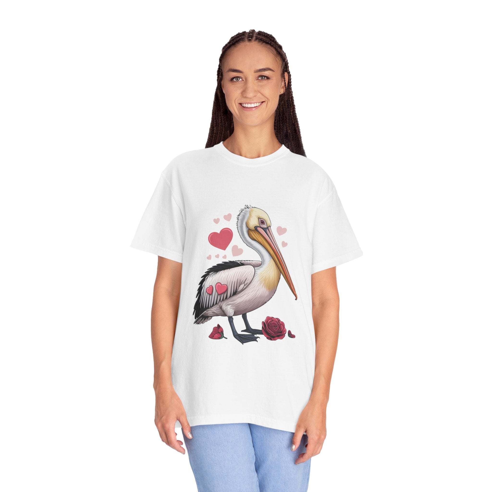 Valentine Pelican Hearts T-Shirt with pelican carrying heart on sunlit shoreline in soft cotton