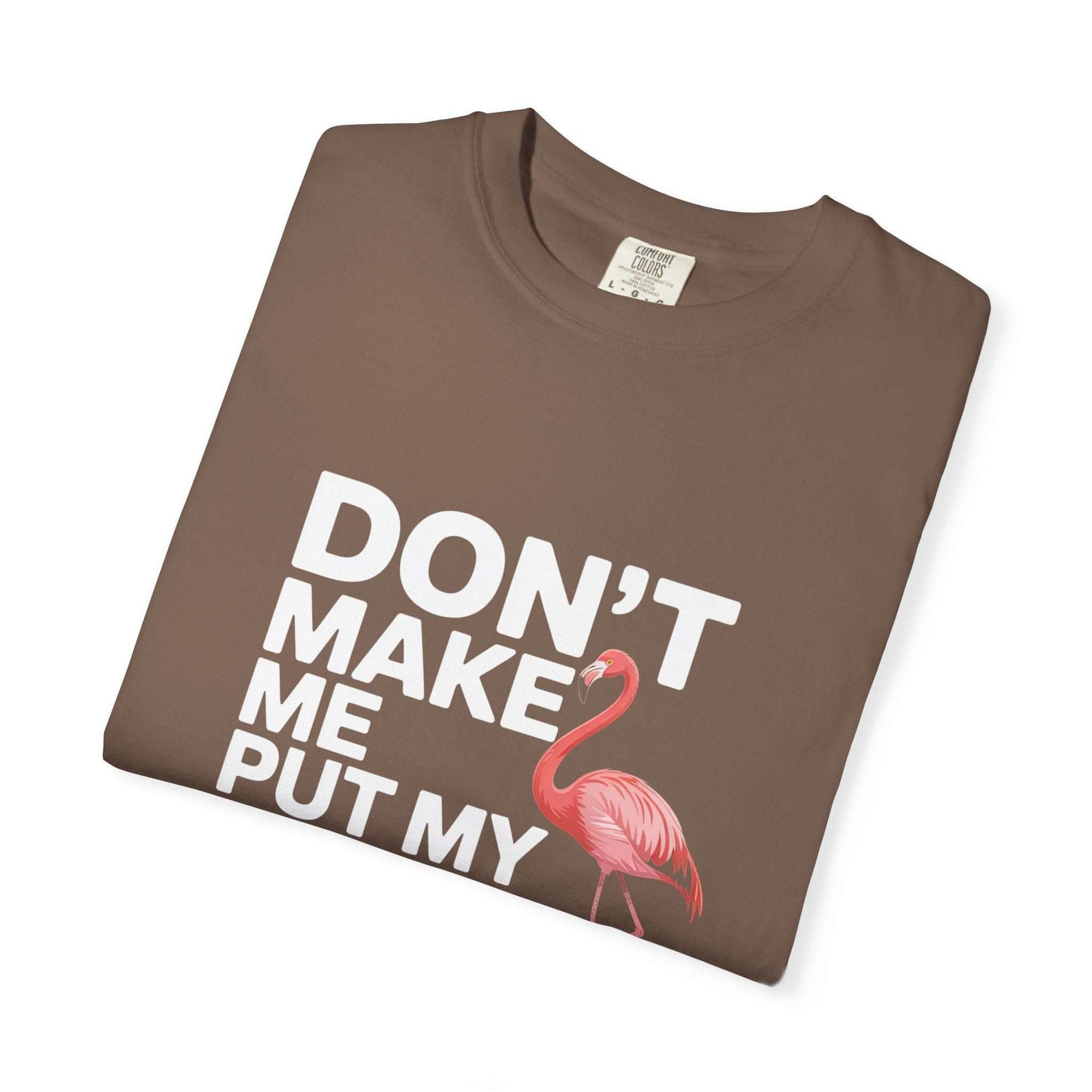 Dont Make Me Put My Foot Down flamingo graphic on vintage pink T-shirt with bold white text