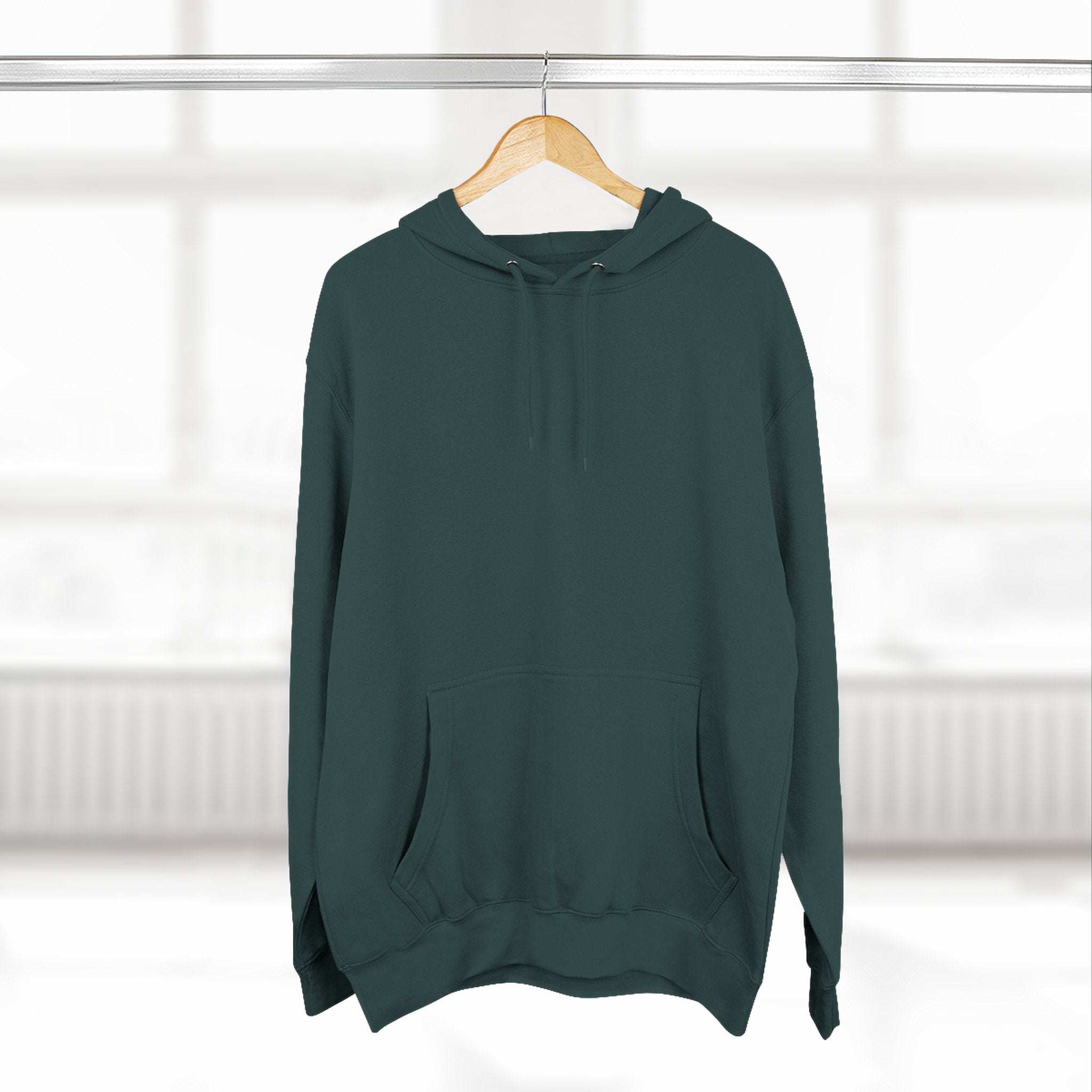 Dark green fleece hoodie with adjustable hood and front pocket hanging on wooden hanger