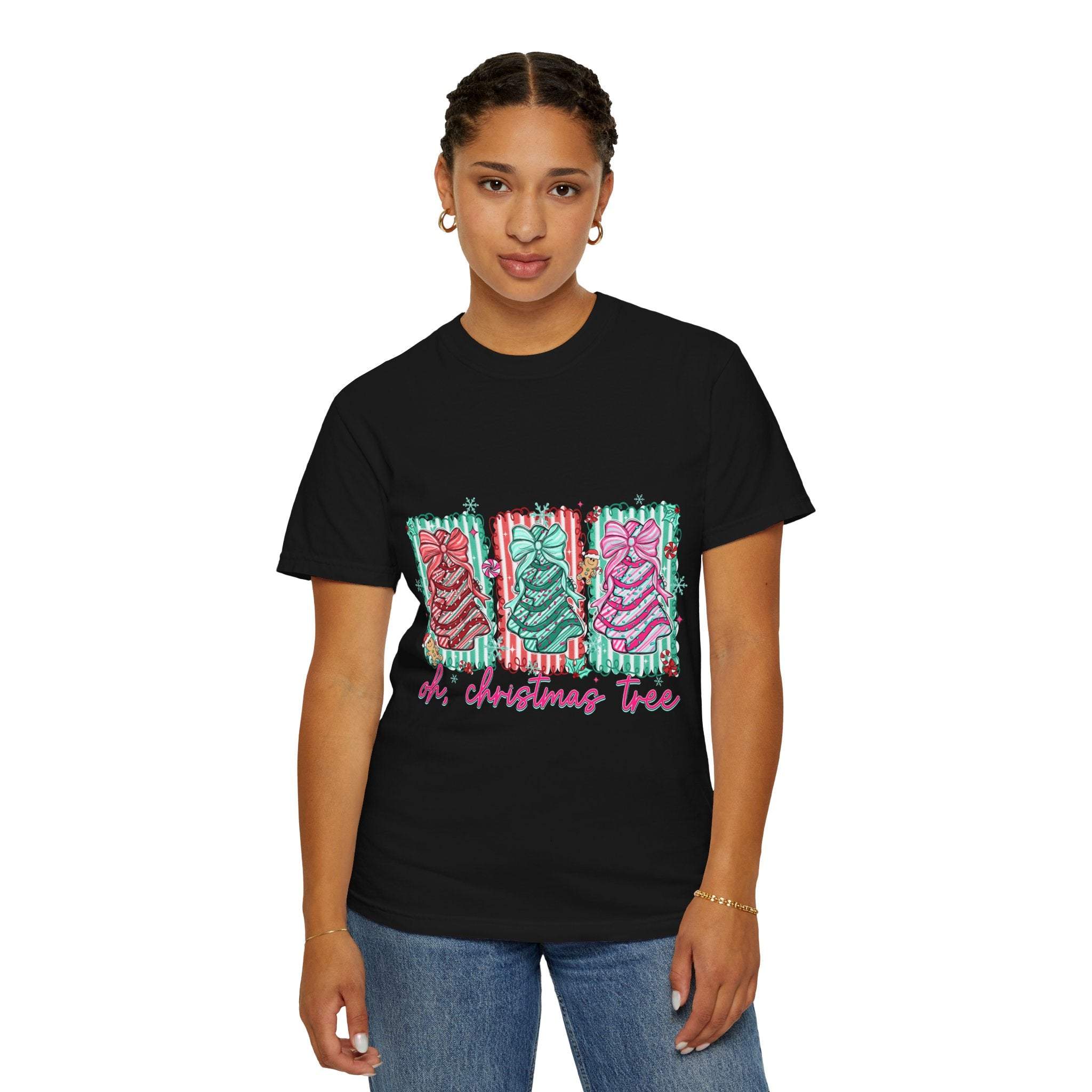 Woman wearing black Oh Christmas Tree T-shirt with festive tree graphics and pink text
