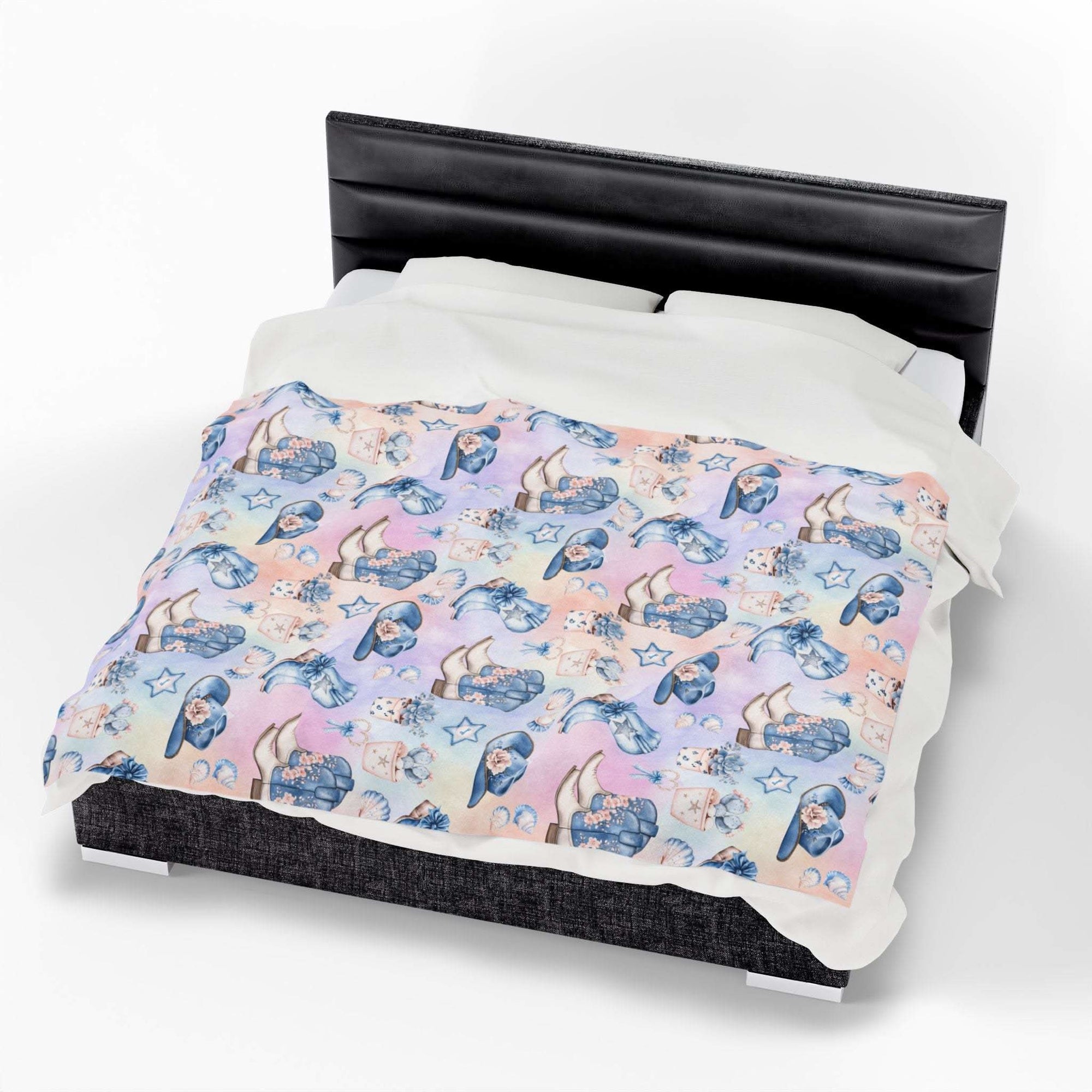 Coastal Cowgirl design plush blanket with pastel beach and horse pattern on bed