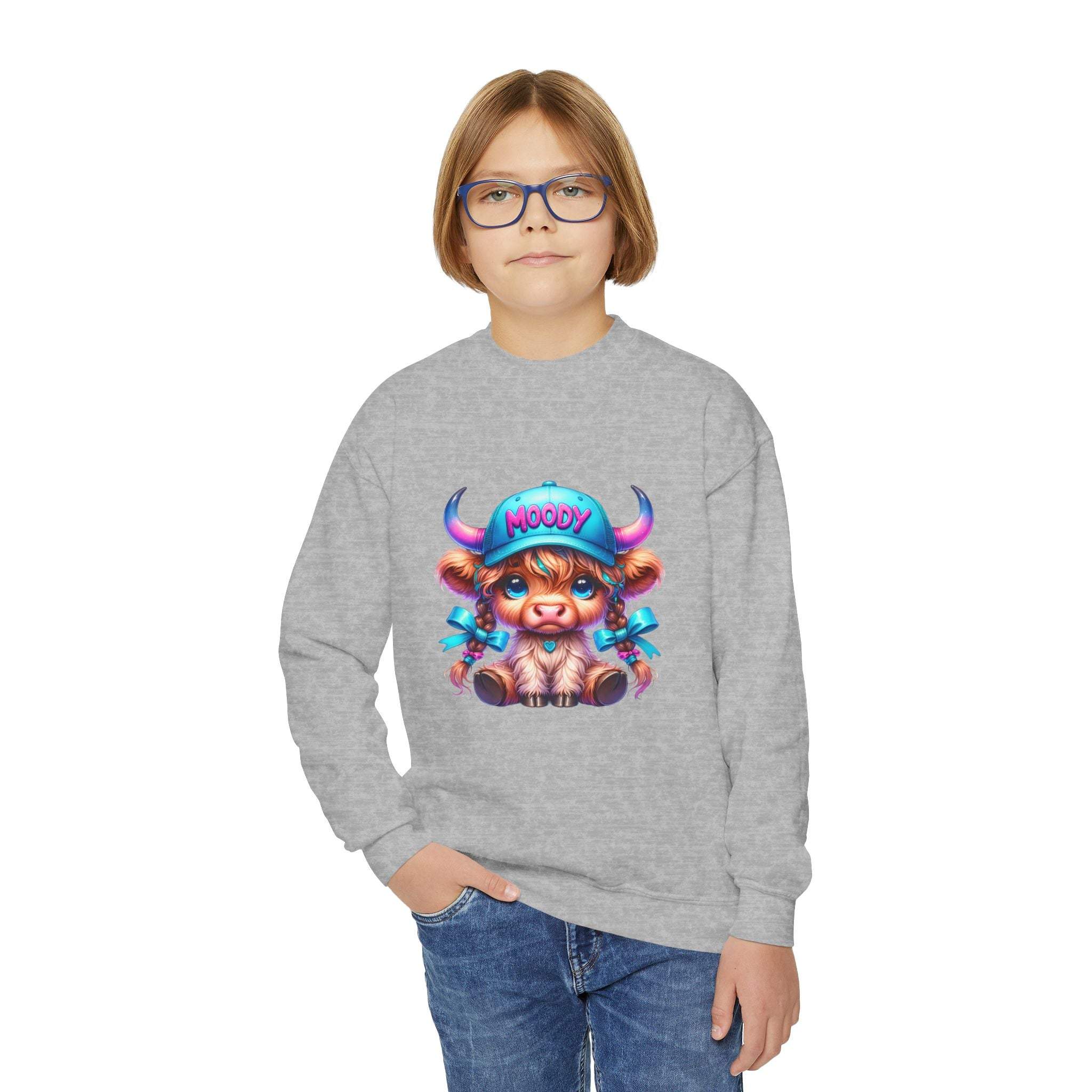 Child wearing gray Moody Girl Highland Cow sweatshirt with colorful cartoon cow design