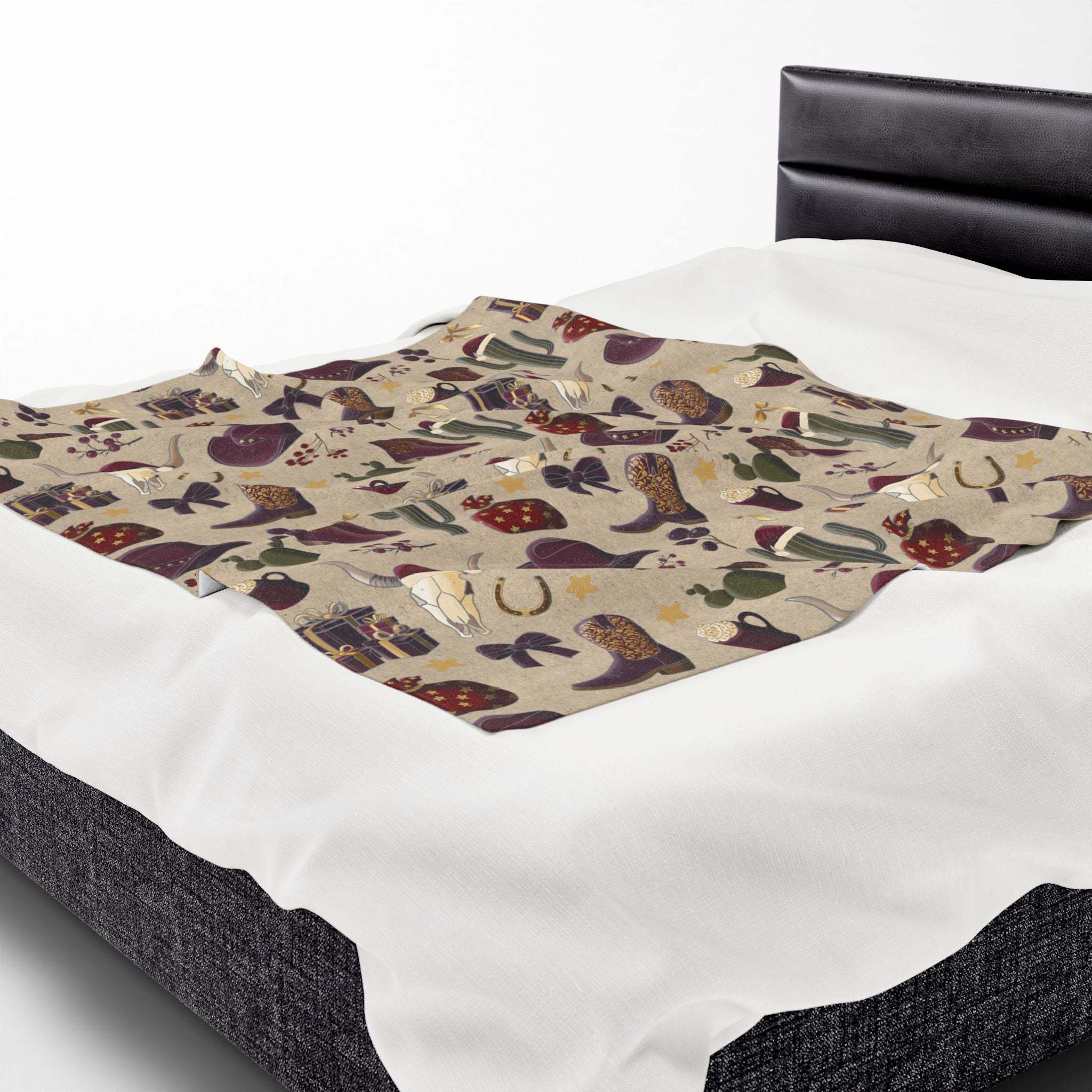 Cozy plush blanket with cowboy Christmas design featuring festive holiday motifs on a bed