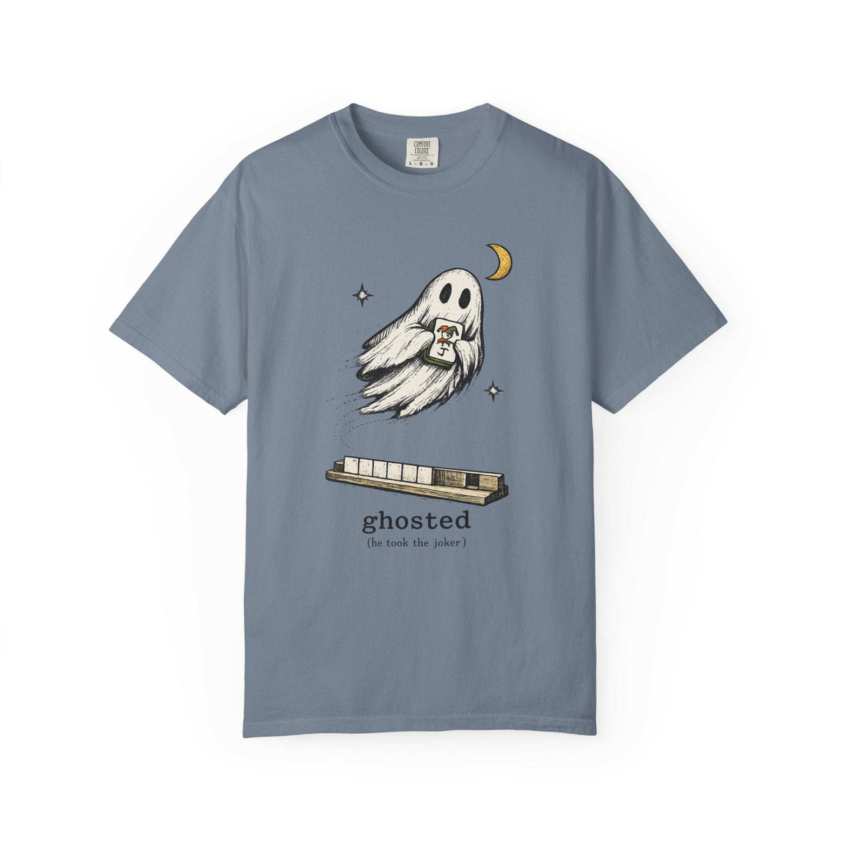 Flat lay of a blue jean mahjong T-shirt with a ghost holding a joker tile above a tile rack and “ghosted (he took the joker)” lettering.