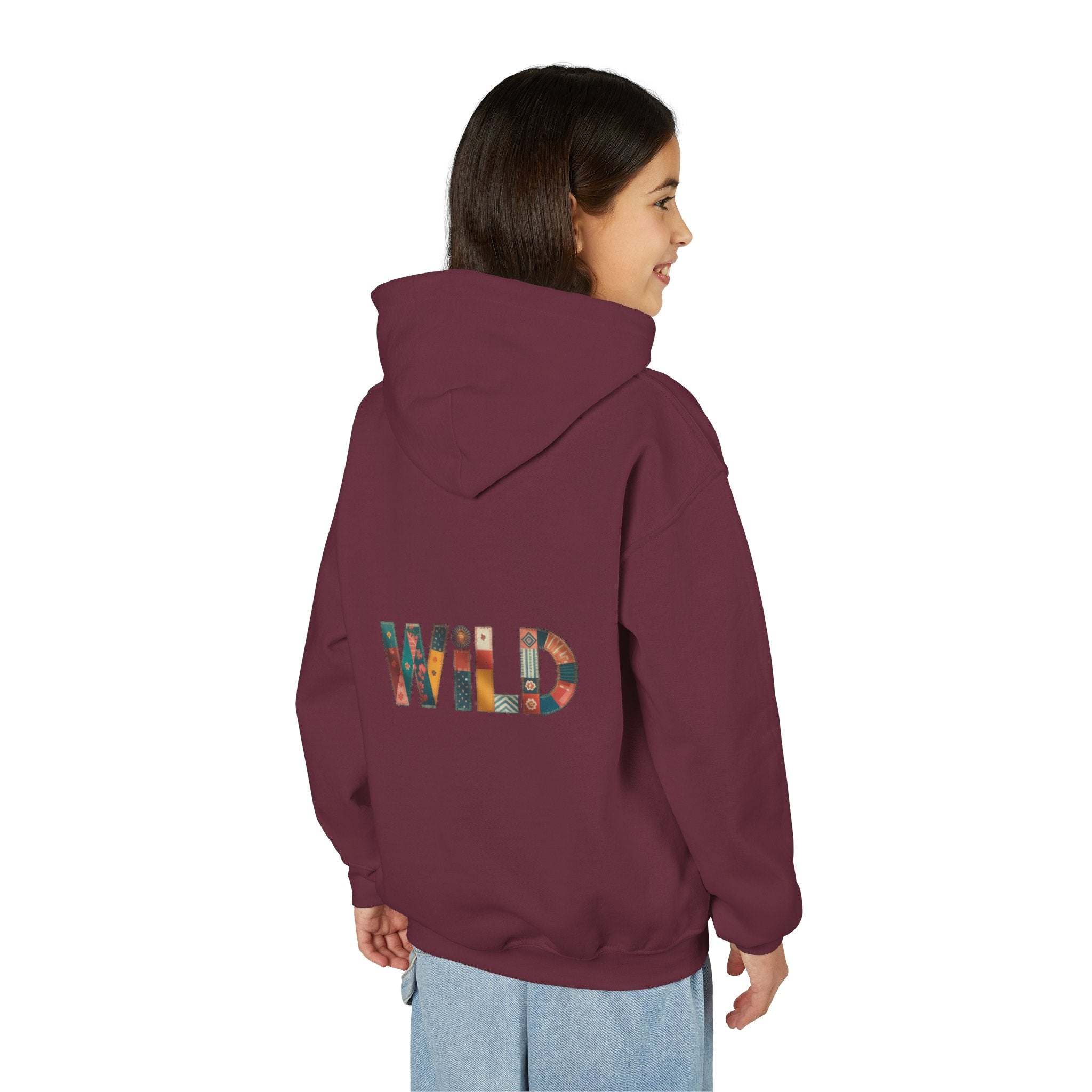 Child wearing maroon Patchwork Wild Word Hoodie with colorful "WILD" text on back and kangaroo pocket.