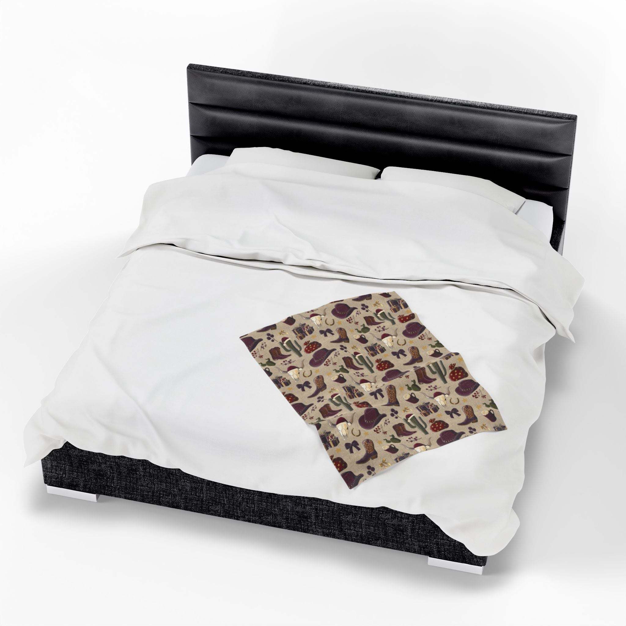 Cozy cowboy Christmas plush blanket with festive western-themed print on bed