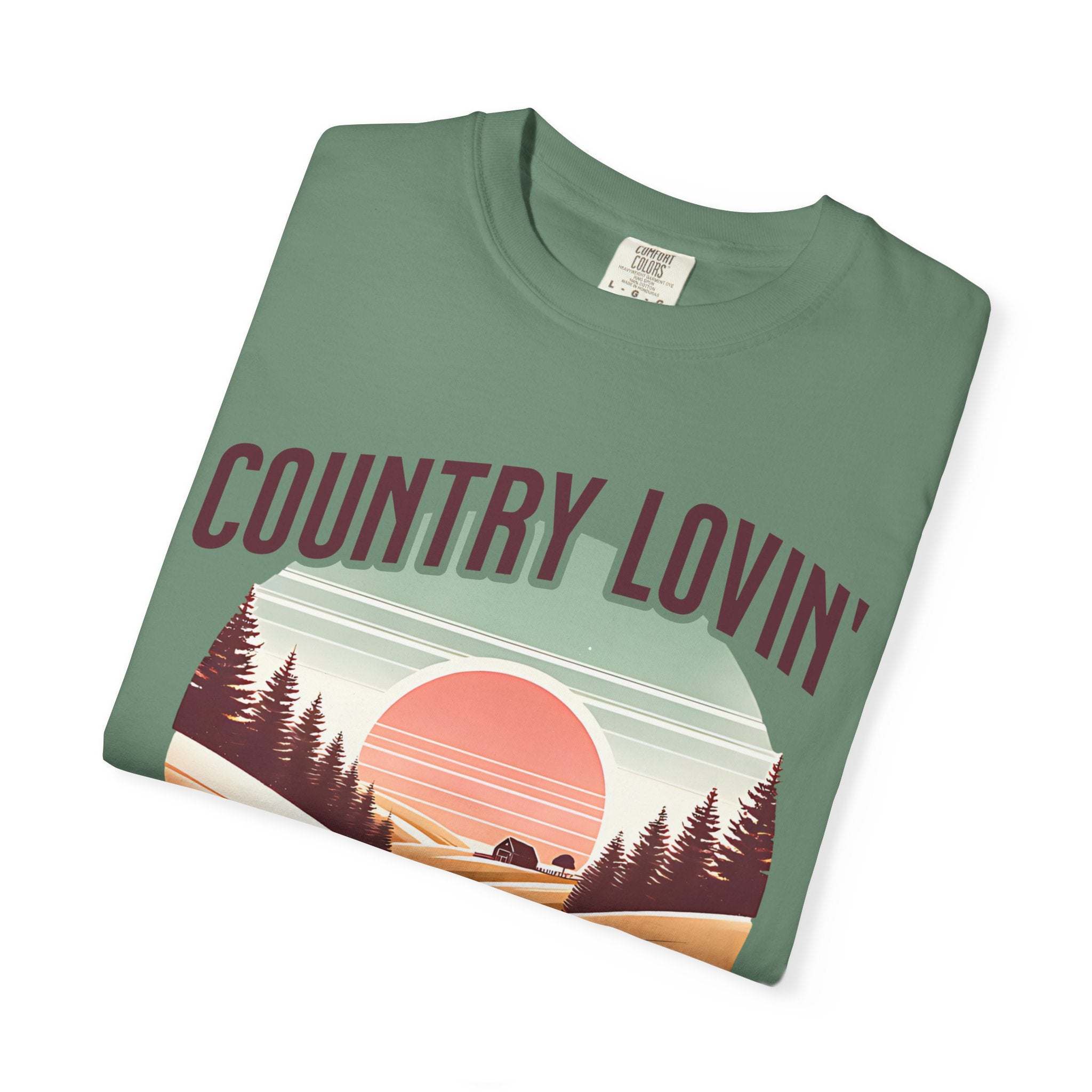 Folded green Country Lovin Girl T-shirt with sunset and forest graphic design