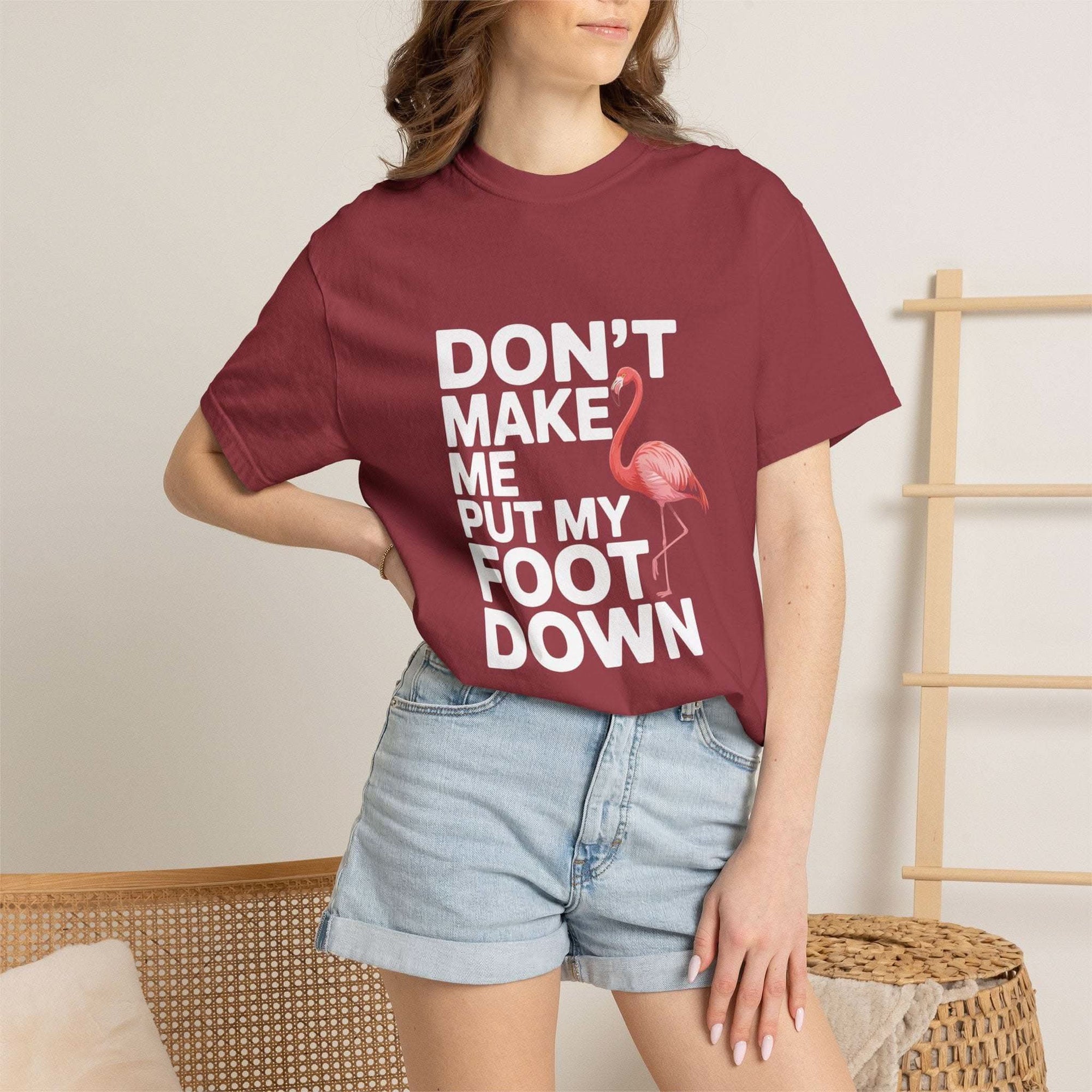 Dont Make Me Put My Foot Down flamingo T-shirt with humorous pink flamingo graphic and bold white text on vintage dyed cotton fabric